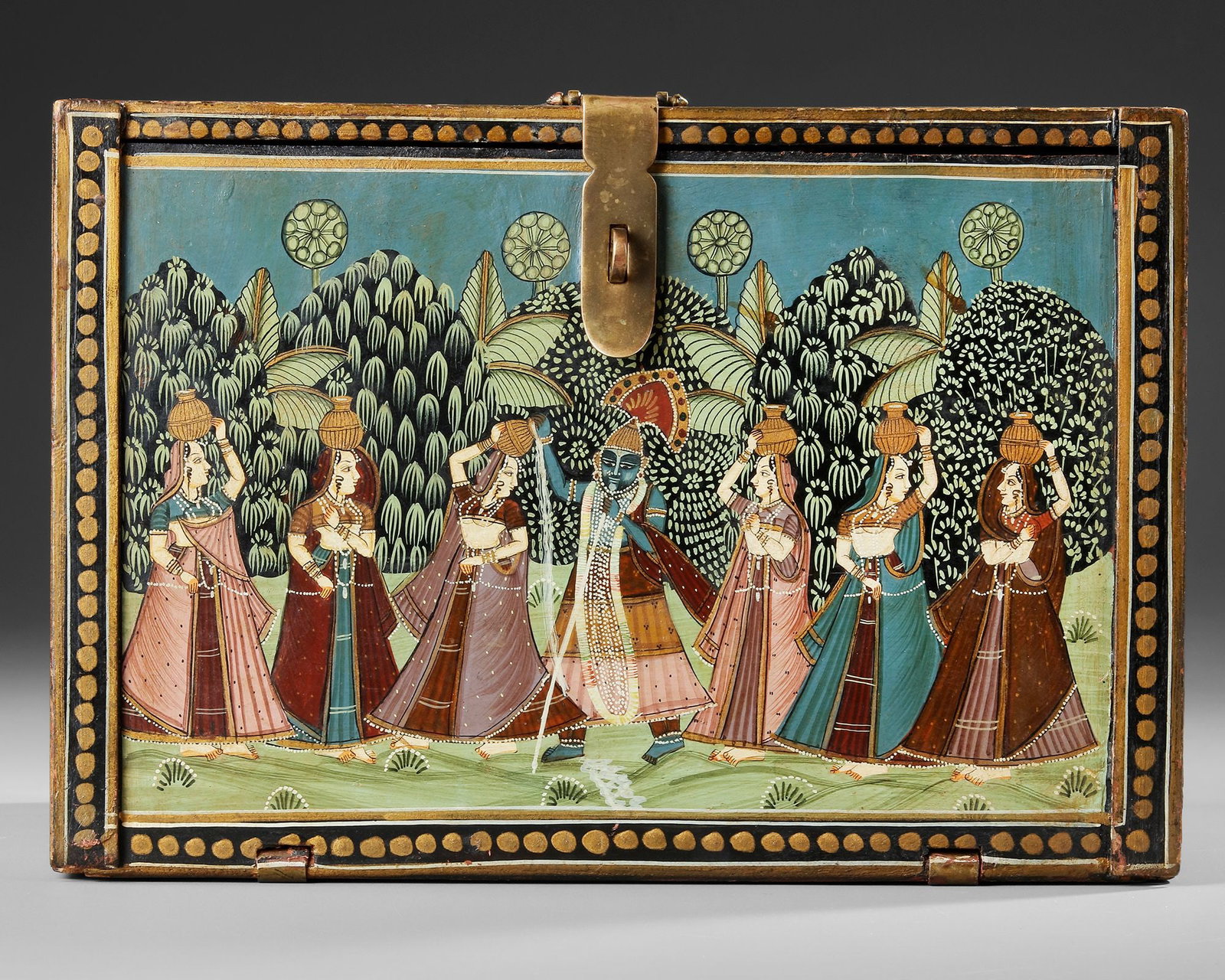 A PAINTED WOOD DEVOTIONAL CABINET (MANDIR), RAJASTHAN, INDIA, 19TH CENTURY: Rectangular in form with a hinged fall-front opening to reveal an arrangement of nine small drawers fitted with turned wooden knobs. The exterior is richly painted in opaque pigments with devotional s