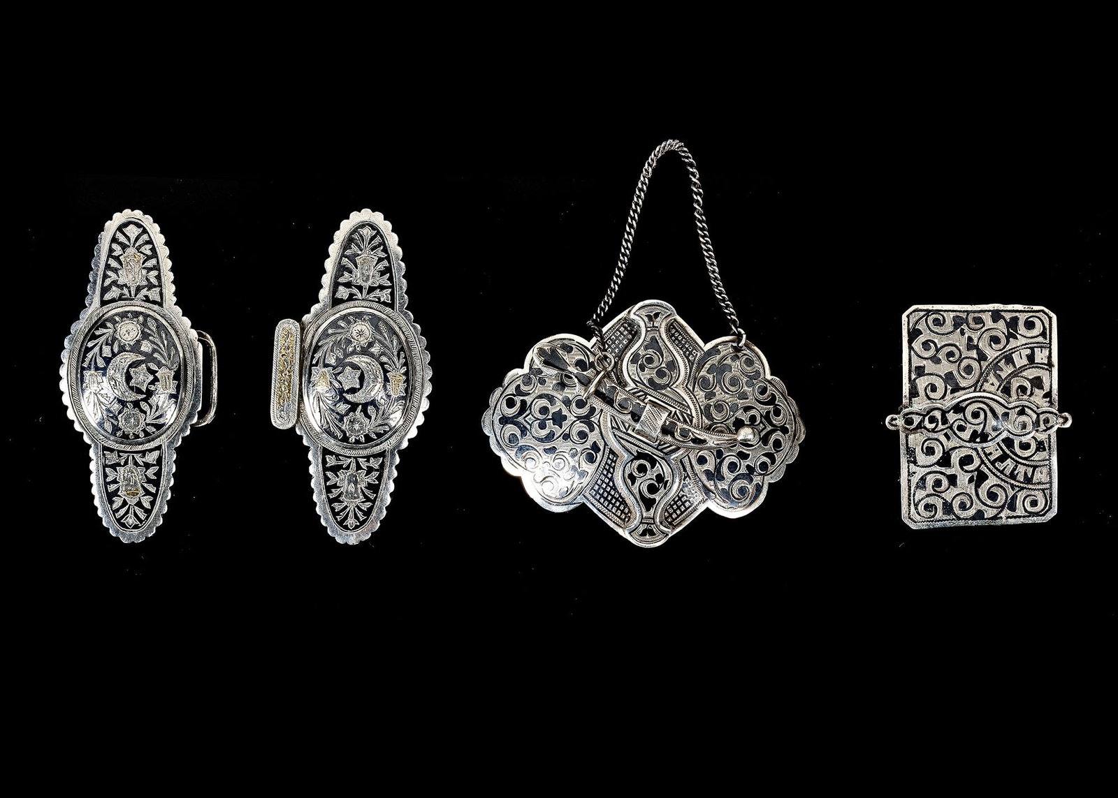 FOUR SILVER BUCKLES, IRAQ, EARLY 20TH CENTURY: Total weight: 136 cm. Between 9 by 4 and 9 by 6 cm.