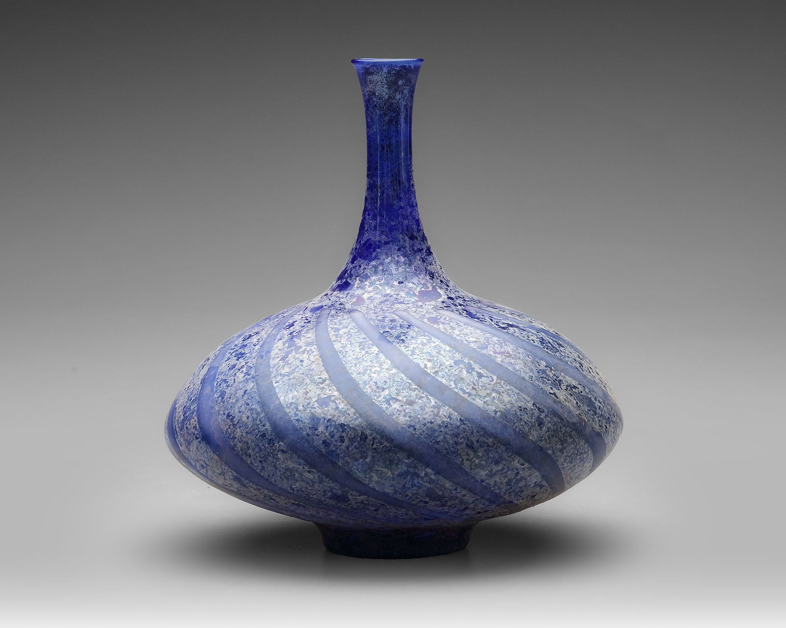 A BLUE GLASS BOTTLE, PERSIA OR SYRIA, 11THâ€“12TH CENTURY (1 of 4)