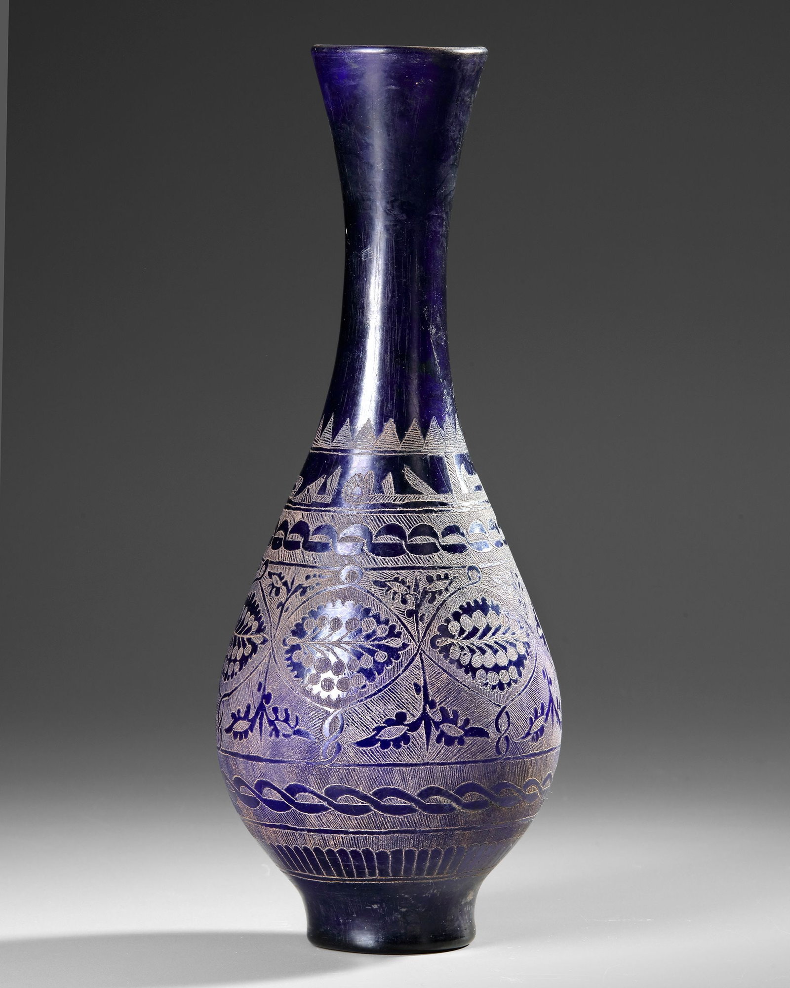 A COBALT BLUE WHEEL-CUT AND ENGRAVED GLASS BOTTLE,MESOPOTAMIA, 10THâ€“12TH CENTURY (1 of 4)