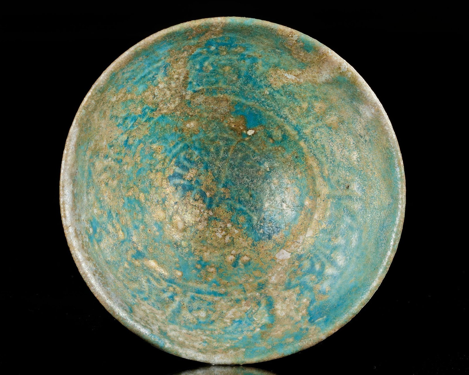 A KASHAN TURQUOISE GLAZED BOWL, PERSIA, 12TH CENTURY: Of conical form, on short straight foot, the interior is covered with a greenish turquoise glaze while the exterior is partially unglazed. Height 6 cm. Diameter 12.5 cm.