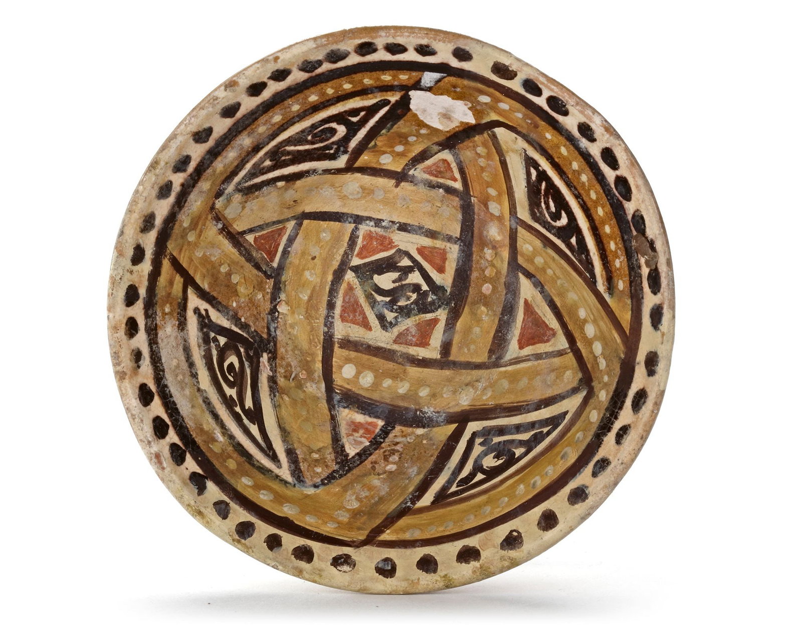 A NISHAPUR POTTERY BOWL, PERSIA, 10TH CENTURY: A Persian pottery bowl, resting on a small foot ring with a slightly flared rim, decorated in ochre, yellow and brown on a cream-colored ground, the interior with roundels and geometric designs enclos