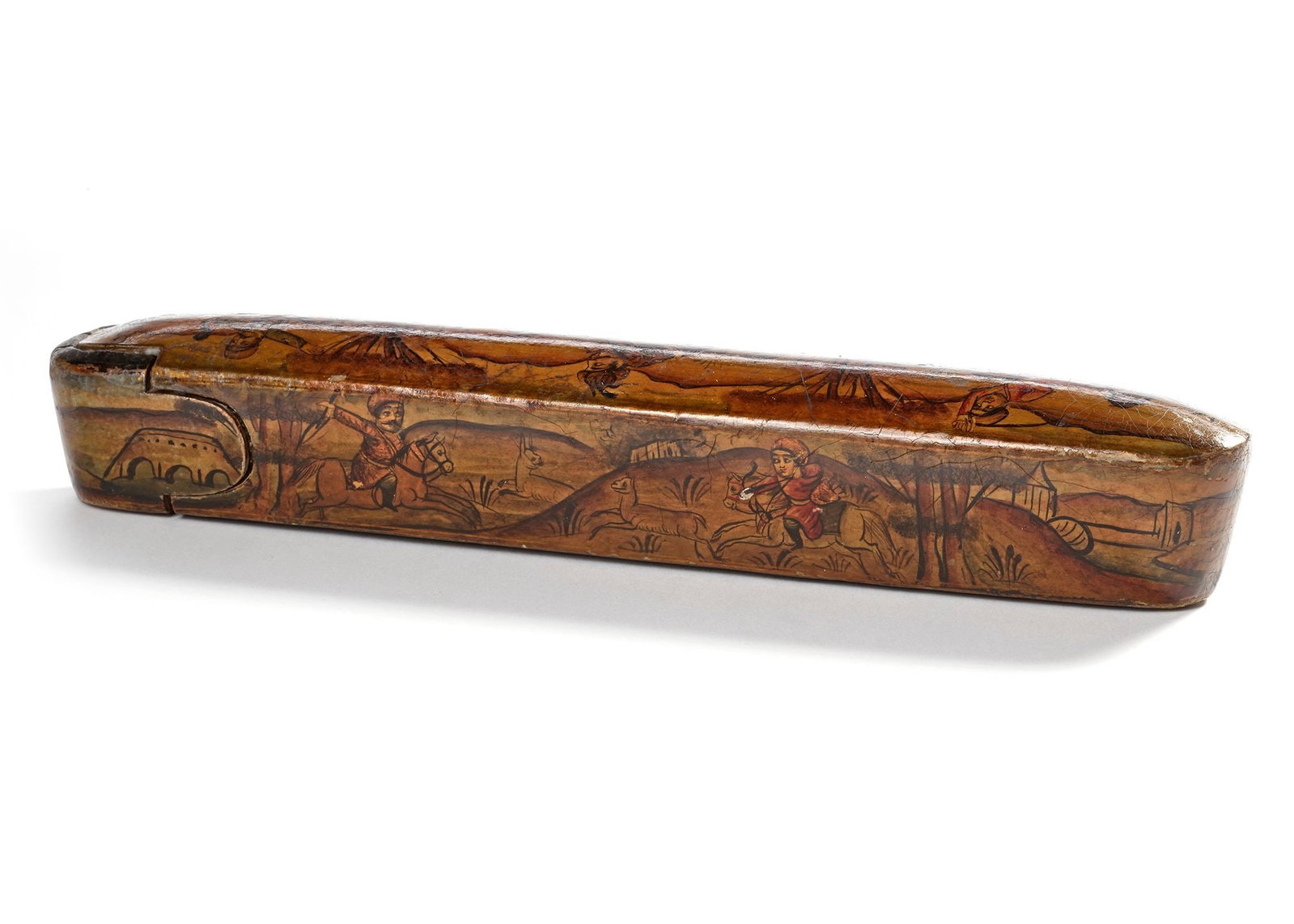 A QAJAR LACQUERED PAPIER-MACH?‰ PEN CASE (QALAMDAN), 19TH CENTURY: Of elongated oval form with a sliding drawer, decorated in gilt and polychrome, the top and sides depict three horsemen in a hunting scene, while the underside and tray are stylized with gilt floral s