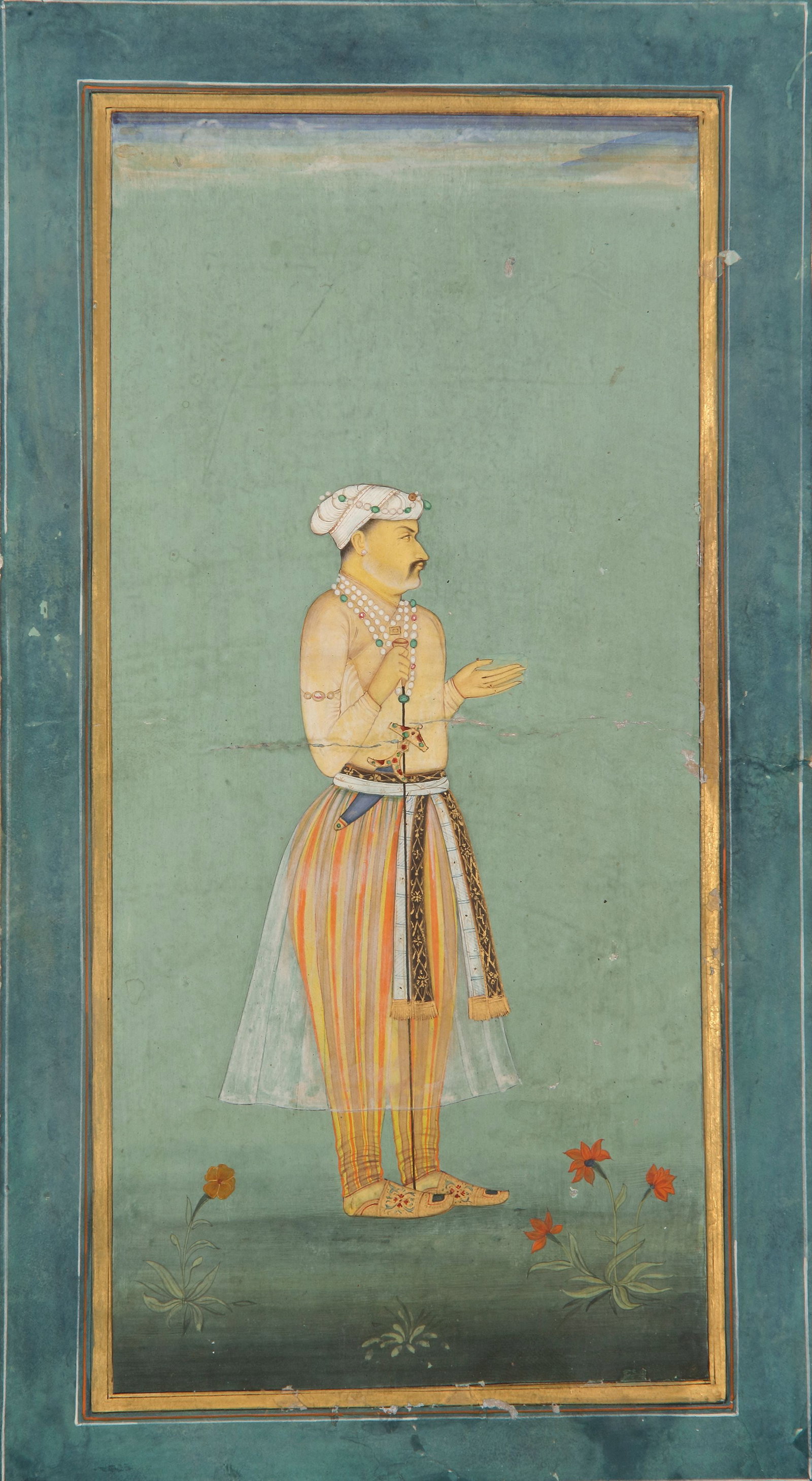 A STANDING PORTRAIT OF A MUGHAL NOBLE, GOUACHE HEIGHTENED WITH GOLD ON PAPER, INDIA, CIRCA 18TH: Opaque pigments heightened with gold on paper, the courtier dressed in a diaphanous white jama and trousers, facing right. 26 by 14 cm. 22.5 by 11 cm.