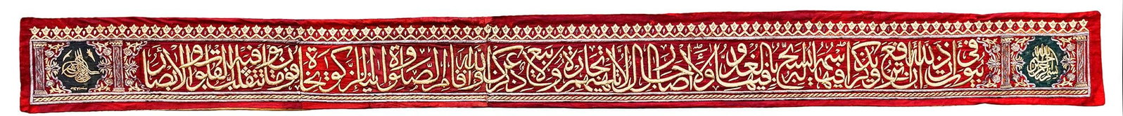 AN OTTOMAN METAL THREAD CALLIGRAPHIC BAND ( HIZAM) FOR THE TOMB OF THE PROPHET IN MEDINA, DATED 1271: A metal thread calligraphic band for the tomb of the prophet (Hujrat Al-Qabr Al-Nabawi Al-Sharif) in Medina, of elongated rectangular form, the red ground embroidered with silver and silver-gilt metal