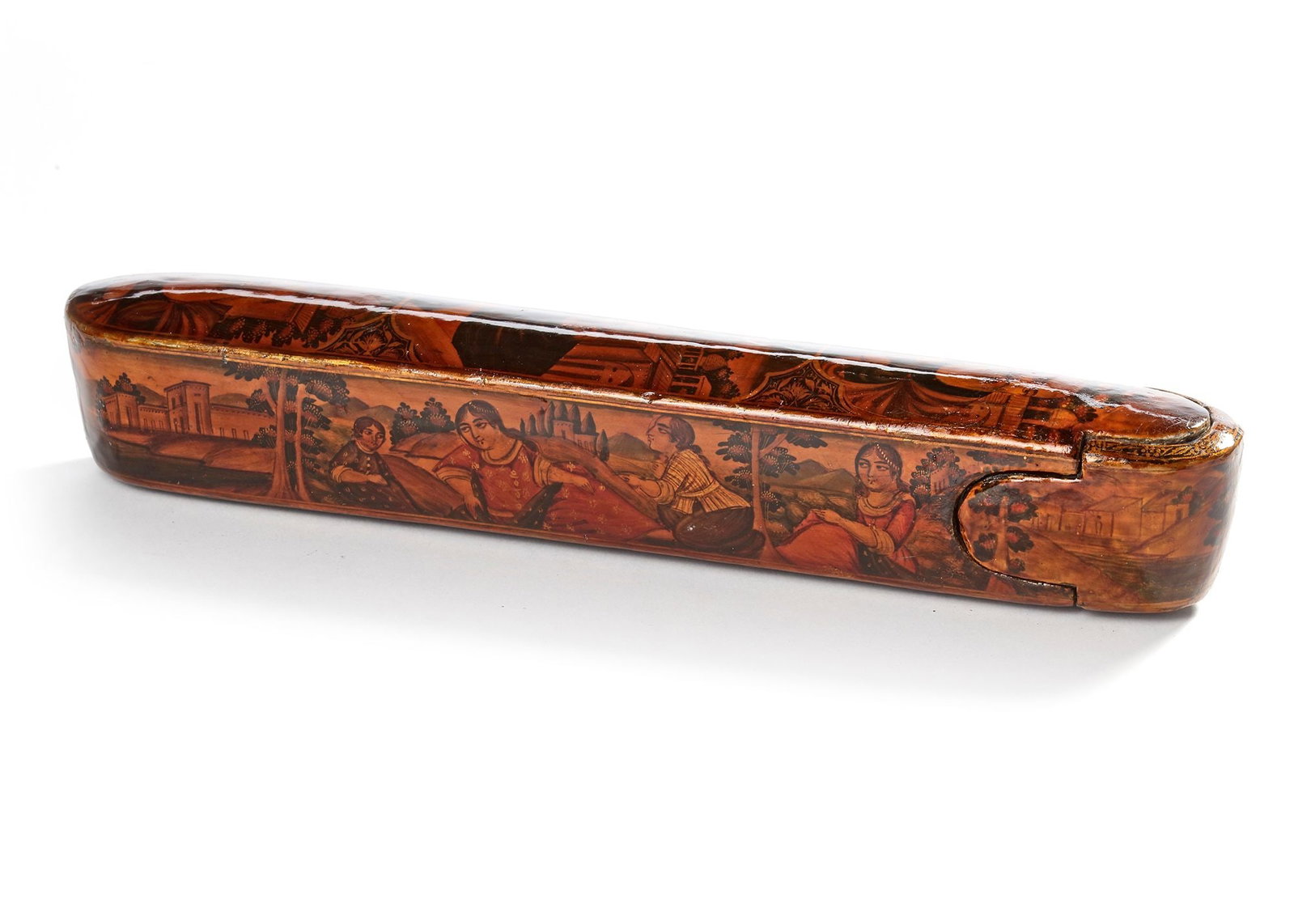 A QAJAR LACQUERED PAPIER-MACH?‰ PEN CASE (QALAMDAN), 19TH CENTURY: Of elongated oval form with sliding drawer, decorated in gilt and polychrome, the top with three cartouches containing depictions of Christian saints, the sides with a landscape and a castle in the ba