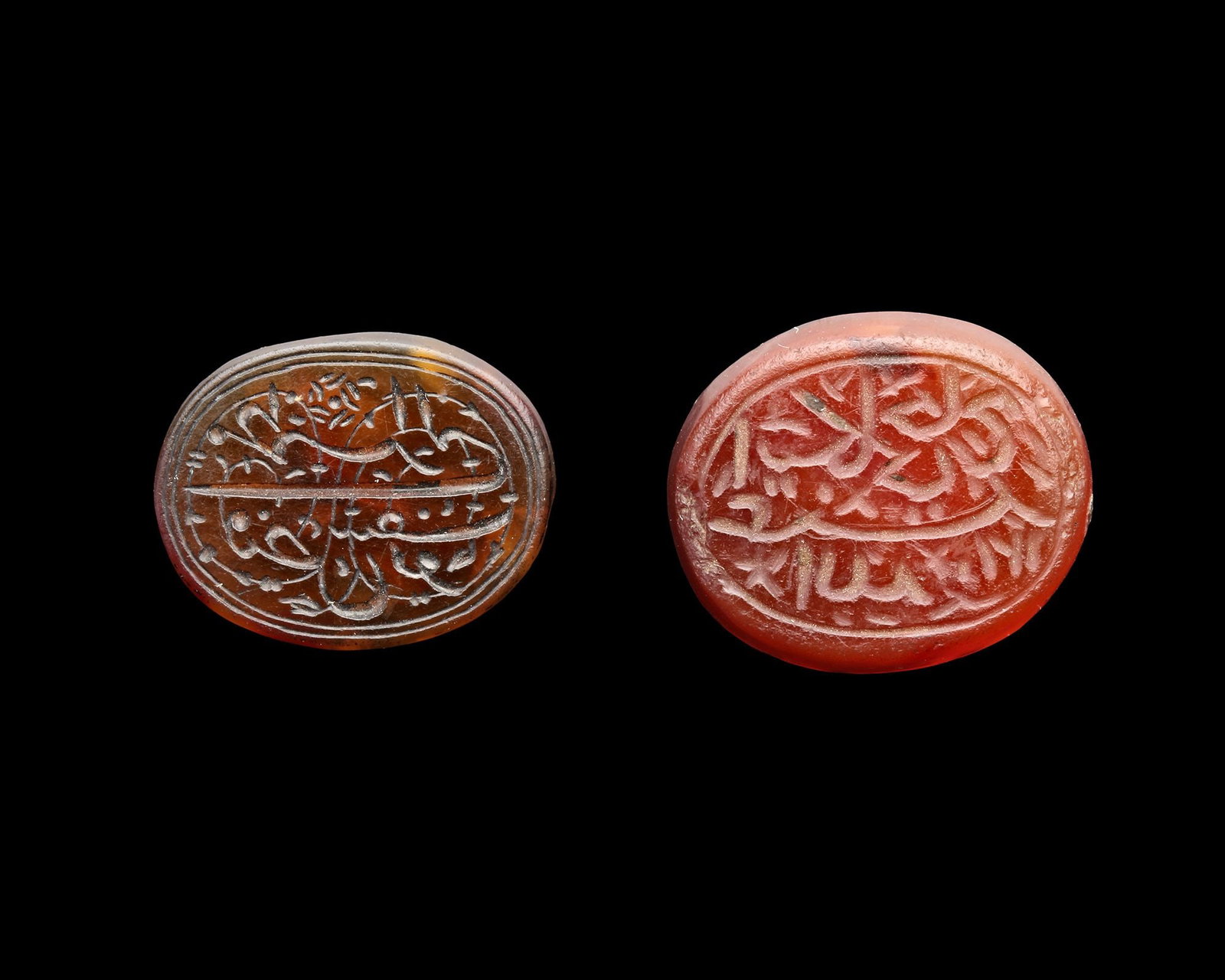 TWO PERSIAN AGATE SEALS, QAJAR PERIOD, 18TH-19TH CENTURY: A Qajar agate seal of rounded form, light brown in colour, engraved in nastaliq script with " ?§?Š?????„?Š ?­?§?¬ ???¨?? ?§?„?„?‡, Itekli Hajj Abdullah", 20.2 cm., dated 1210AH/ 1795 A