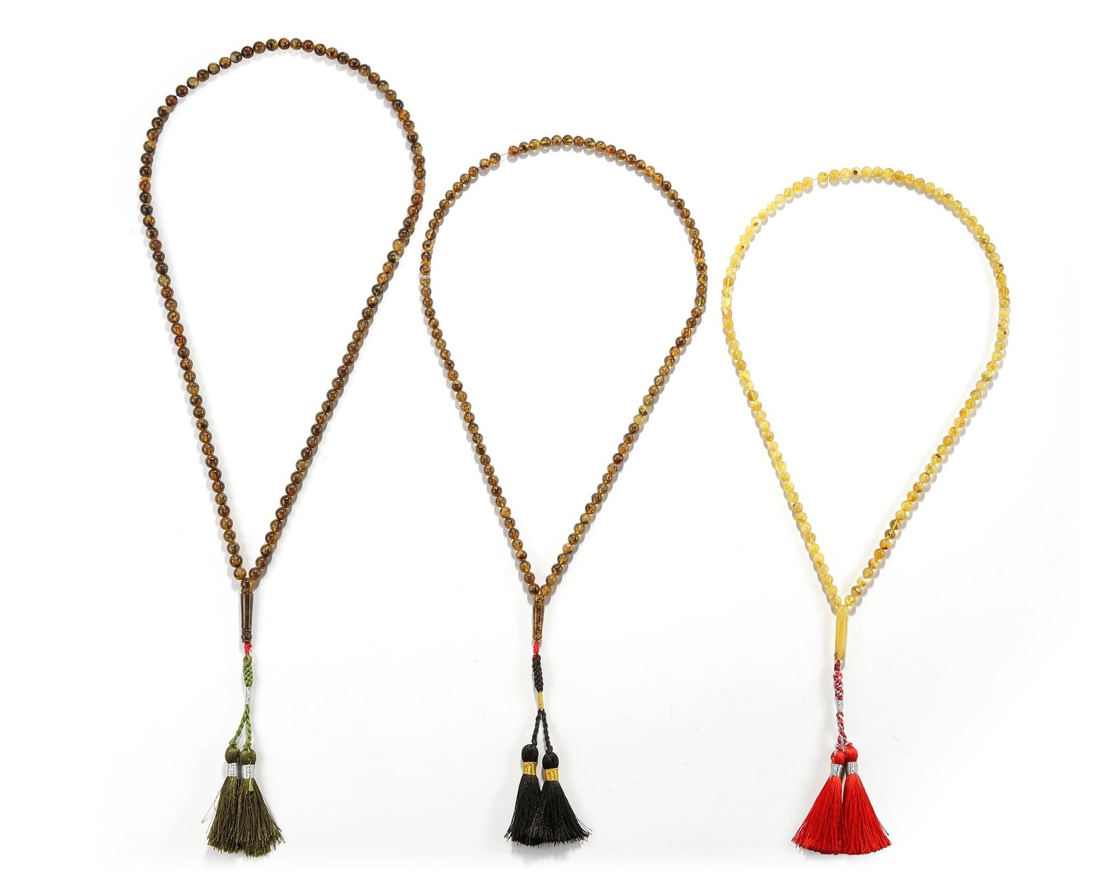 A COLLECTION OF THREE TASBIHS, 20TH CENTURY: Length ca. between 60 cm. and 54 cm. Total weight 119 gr. 101 beads. 99 beads. 99 beads.