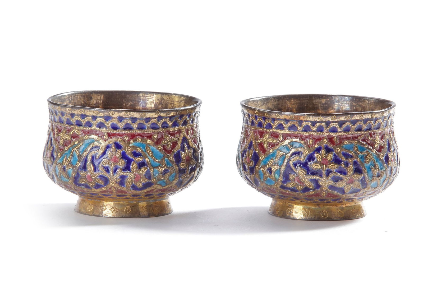 TWO INDIAN SILVER ENAMEL CUPS, 19TH CENTURY: Richly decorated with vibrant polychrome enamel in floral and geometric motifs. The interiors are gilded. 6 by 4 cm. 224 gr. THE DR. SAAD AL-JADIR COLLECTION