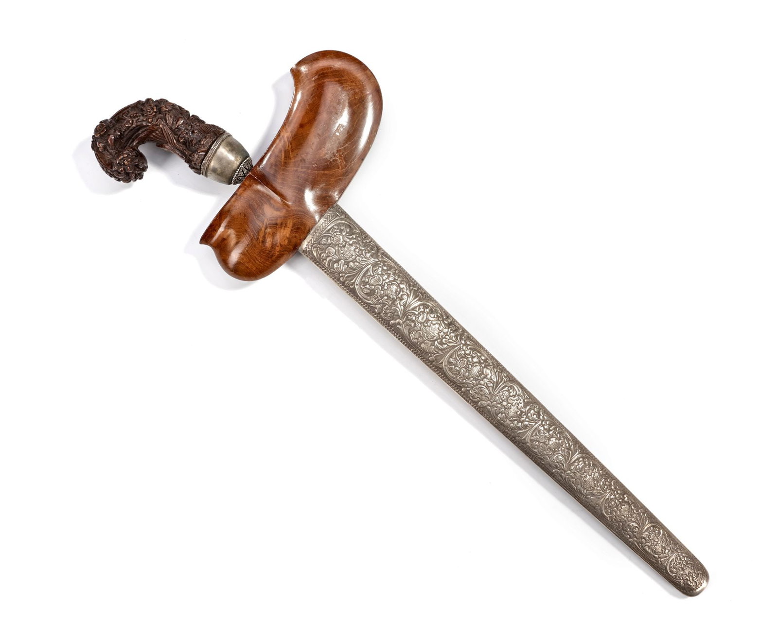A SILVER INDONESIAN KRIS, 19TH CENTURY: With a finely carved wooden hilt, a distinctive wavy-patterned blade, and a silver scabbard richly decorated with floral motifs. 52 cm. 532 gr. THE DR. SAAD AL-JADIR COLLECTION