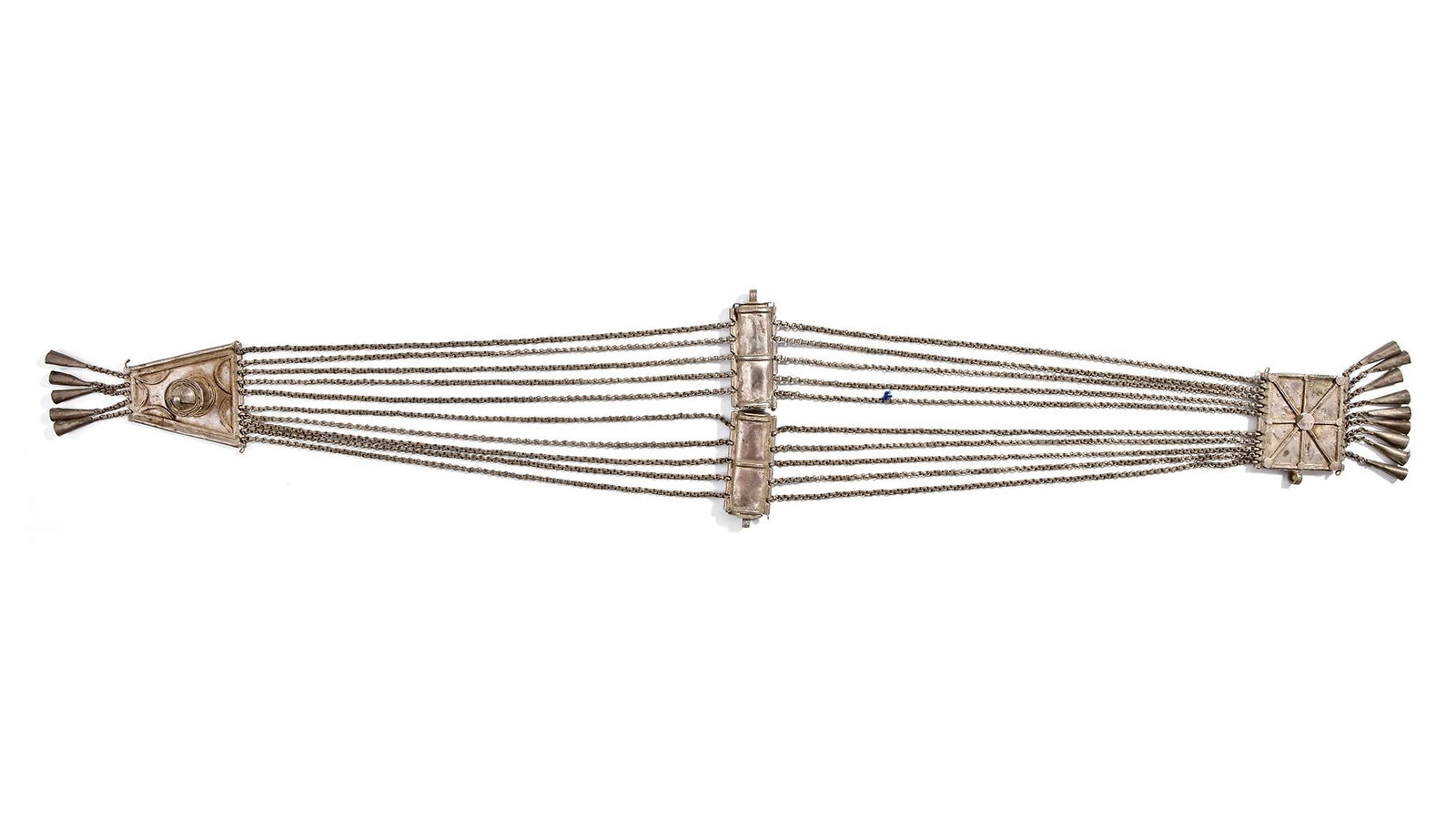 AN OTTOMAN SILVER BELT, 19TH CENTURY: Composed of multiple chains connected by decorated plaques. The central clasp features a compartment, flanked by triangular and square end-pieces adorned with pendants. 70 cm. 310 gr. THE DR. SAAD AL-