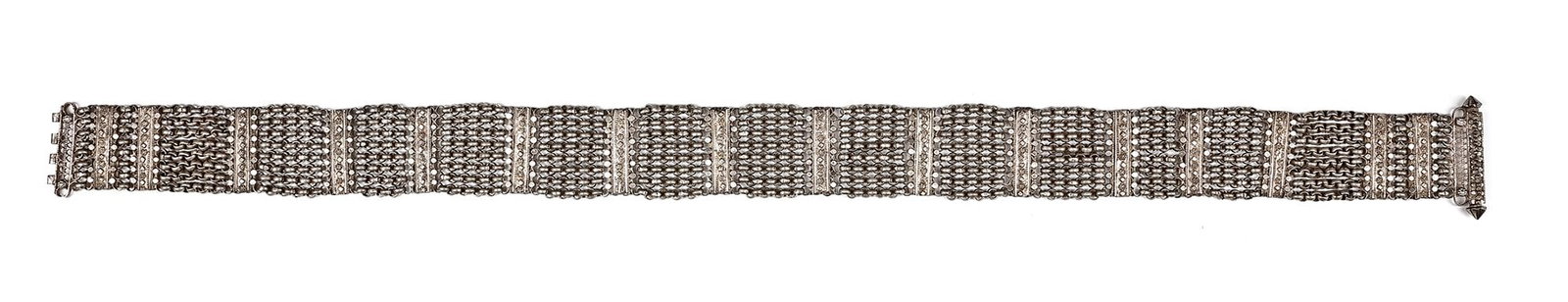 A SILVER BELT, OMAN, 19TH CENTURY: Crafted with intricate chain-link work and decorated with finely engraved panels. The wide design is both ornamental and functional, featuring a bold central clasp with geometric and floral detailing.