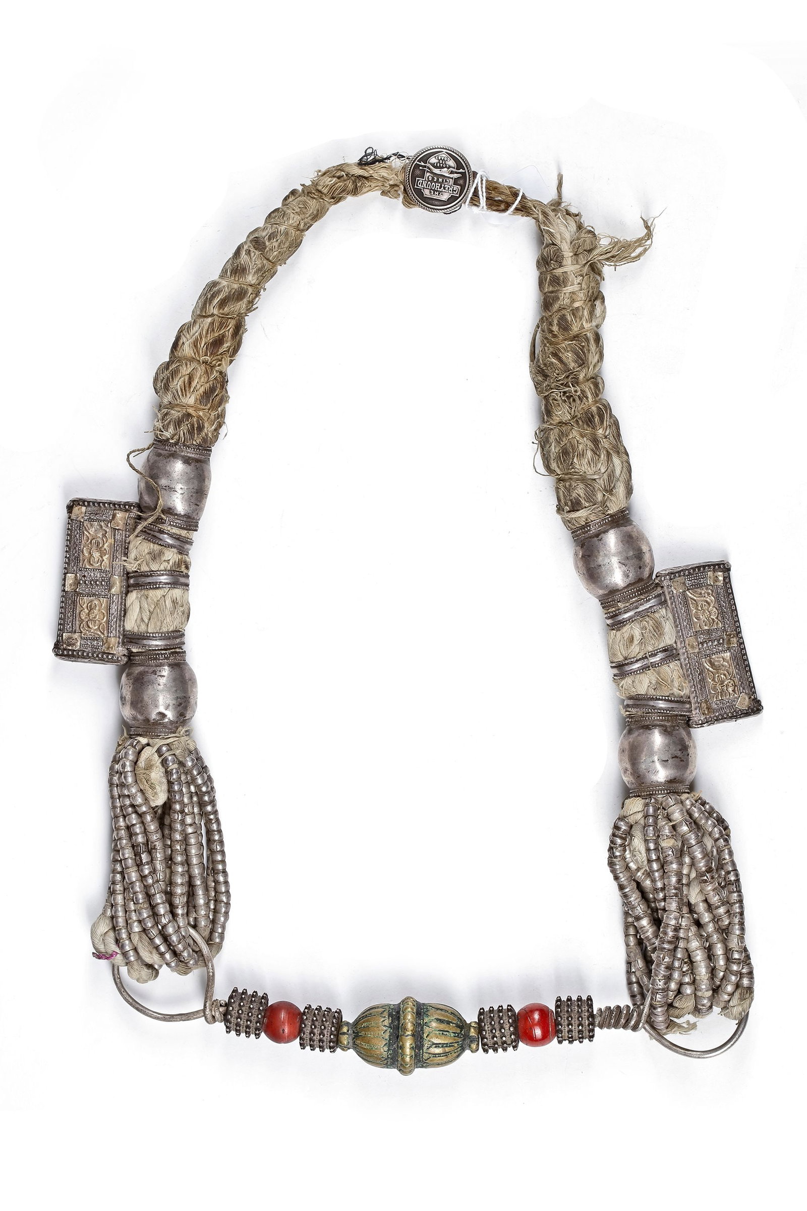A SILVER NECKLACE, OMAN, 19TH CENTURY: Featuring braided cord sections with large silver beads, decorated amulet cases, and cascading bead tassels. 500 gr. THE DR. SAAD AL-JADIR COLLECTION