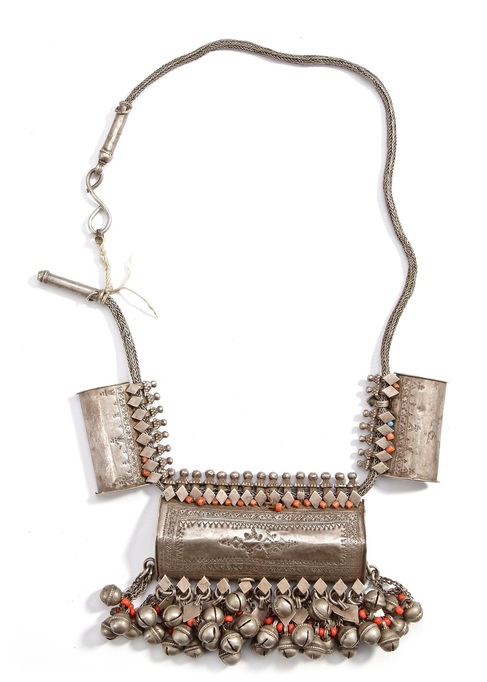 A SILVER NECKLACE, YEMEN, 19TH CENTURY: Featuring an amulet case with fine engraved patterns, adorned with coral beads and multiple hanging bells. 77 cm. 414 gr. THE DR. SAAD AL-JADIR COLLECTION