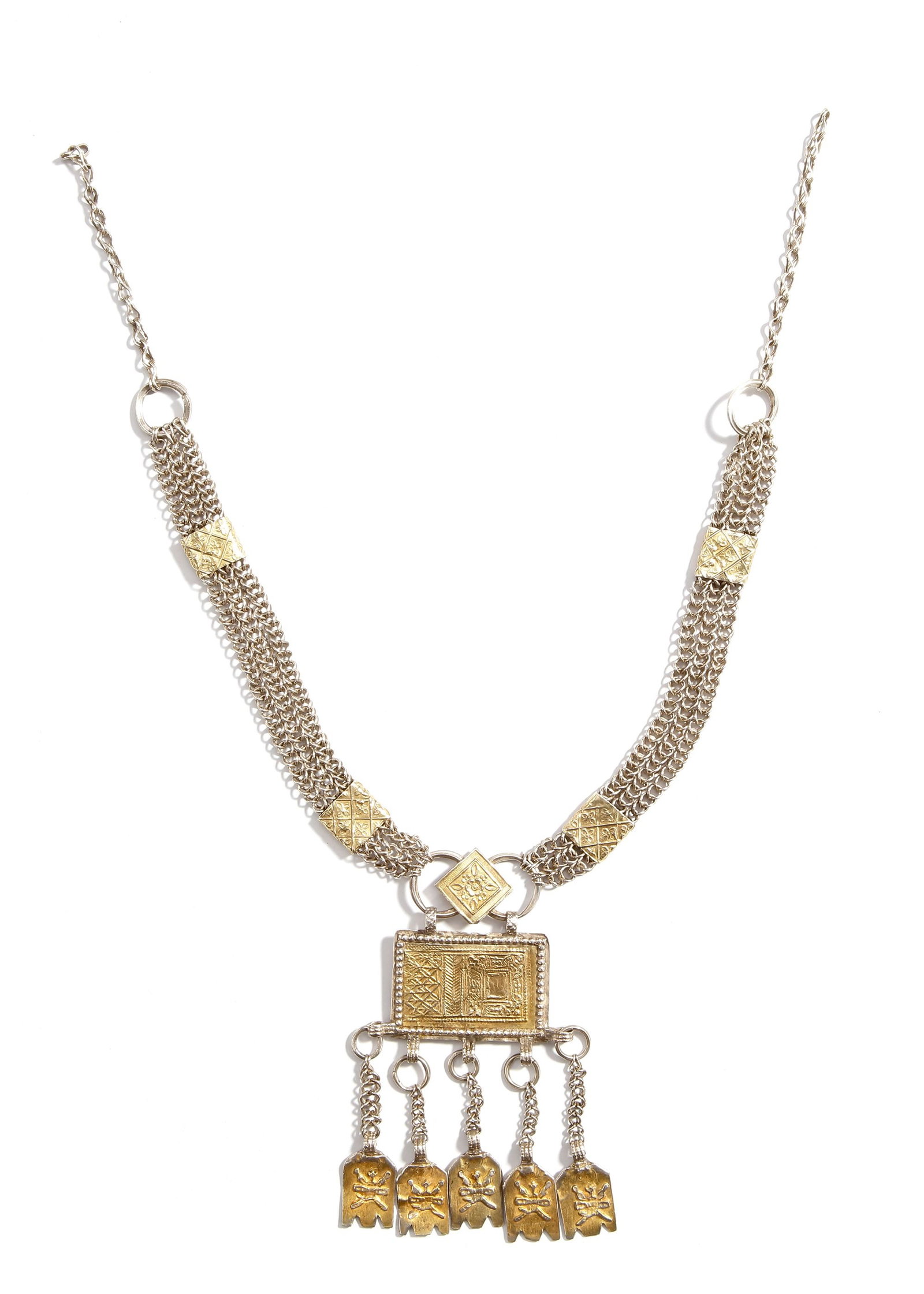 SILVER NECKLACE, OMAN, 19TH CENTURY: A finely crafted Omani silver necklace, richly decorated with geometric and floral motifs, highlighted with partial gilding. The central rectangular pendant is adorned with intricate patterns and susp