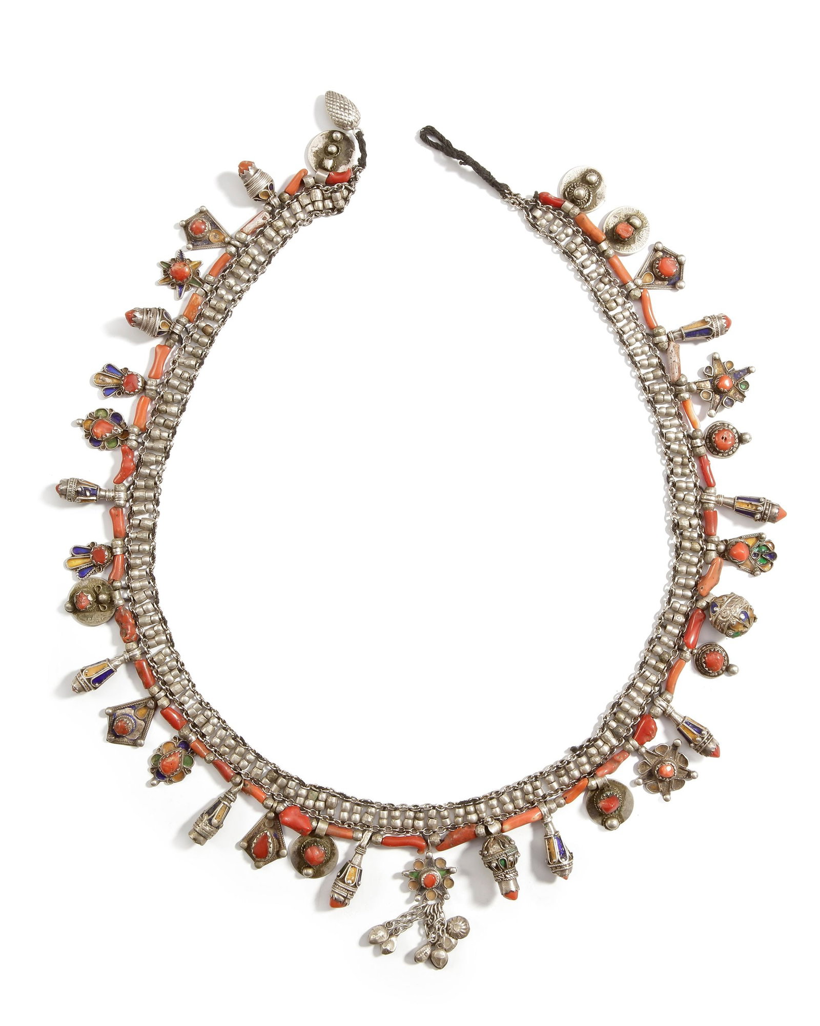 A SILVER NECKLACE, MOROCCO, 19TH CENTURY: Adorned with red coral branches, enamel details, and multiple pendant charms. Richly decorated with geometric and floral motifs. ca. 70 cm. 223 gr. THE DR. SAAD AL-JADIR COLLECTION