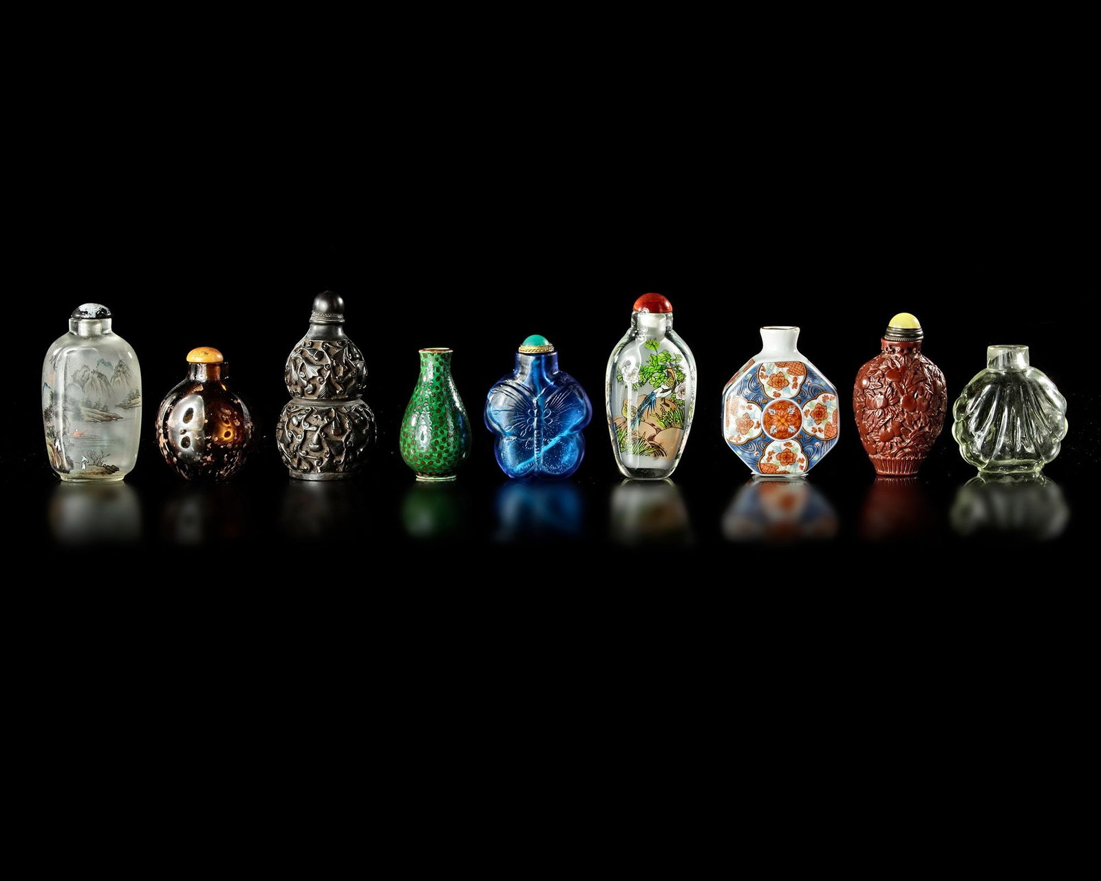 A COLLECTION OF 9 SNUFF BOTTLES IN VARIOUS MATERIALS, QING DYNASTY (1644-1911) (1 of 2)