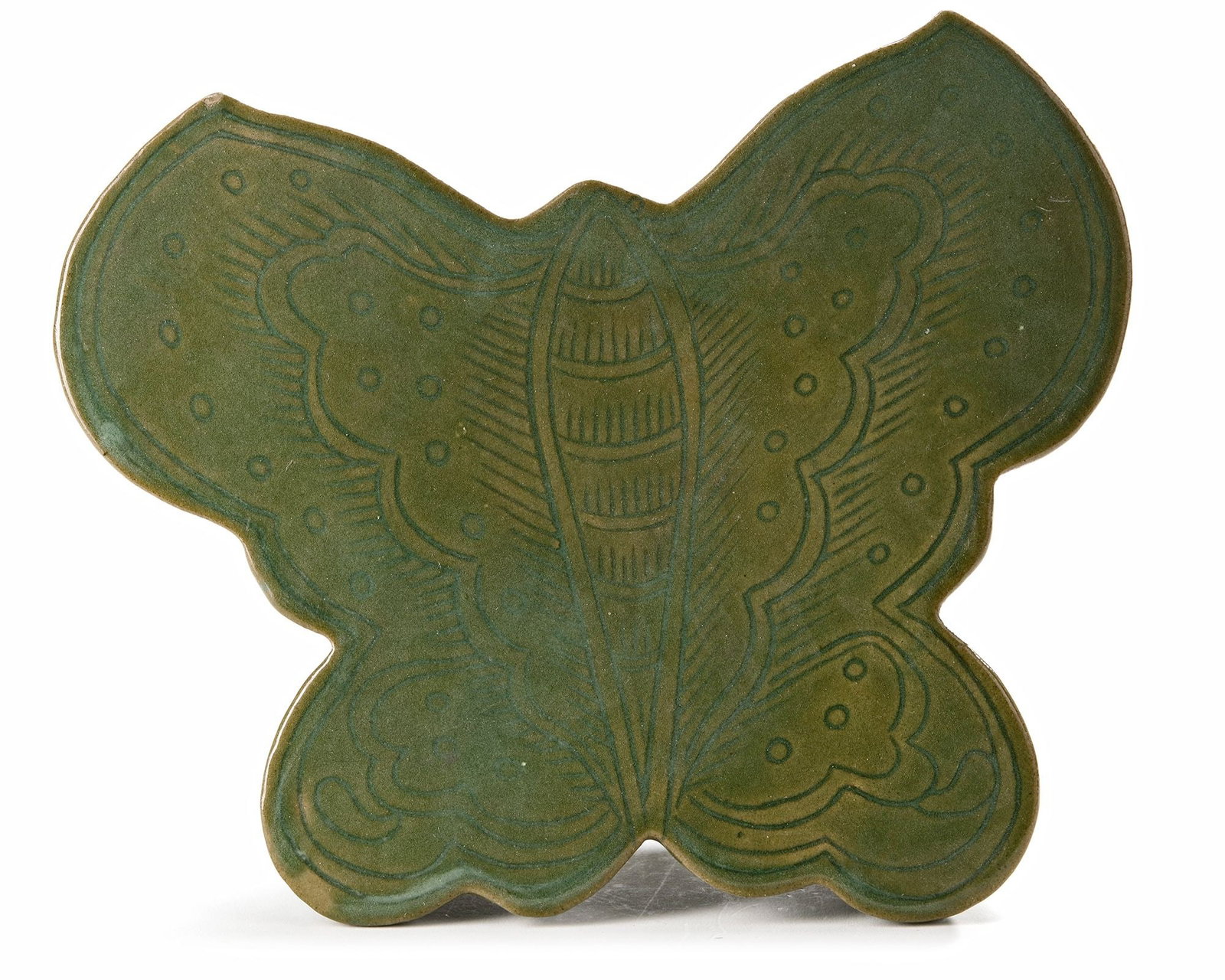 A CHINESE CELADON BUTTERFLY SHAPED PILLOW, 19TH CENTURY: A Chinese porcelain pillow in the shape of butterfly, carved on the surface with details of the body and the wings, covered overall with an olive-green glaze, the base is unglazed. 22 by 26 cm.