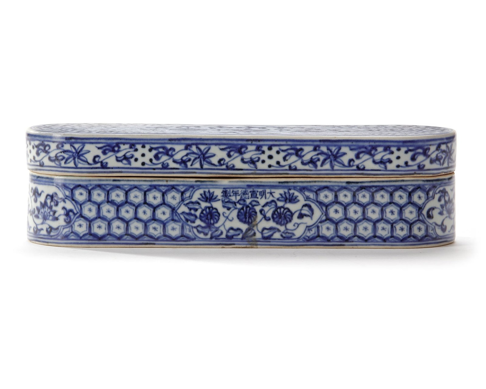 A CHINESE BLUE AND WHITE PEN BOX AND COVER FOR THE ISLAMIC MARKET, XUANDE MARK, 19TH CENTURY: The cover is decorated with a shaped panel enclosing floral scrolls, all reserved on ground of dense 'golden horn' scrolls. The box base is decorated with four cartouches enclosing scrolling flowers, 