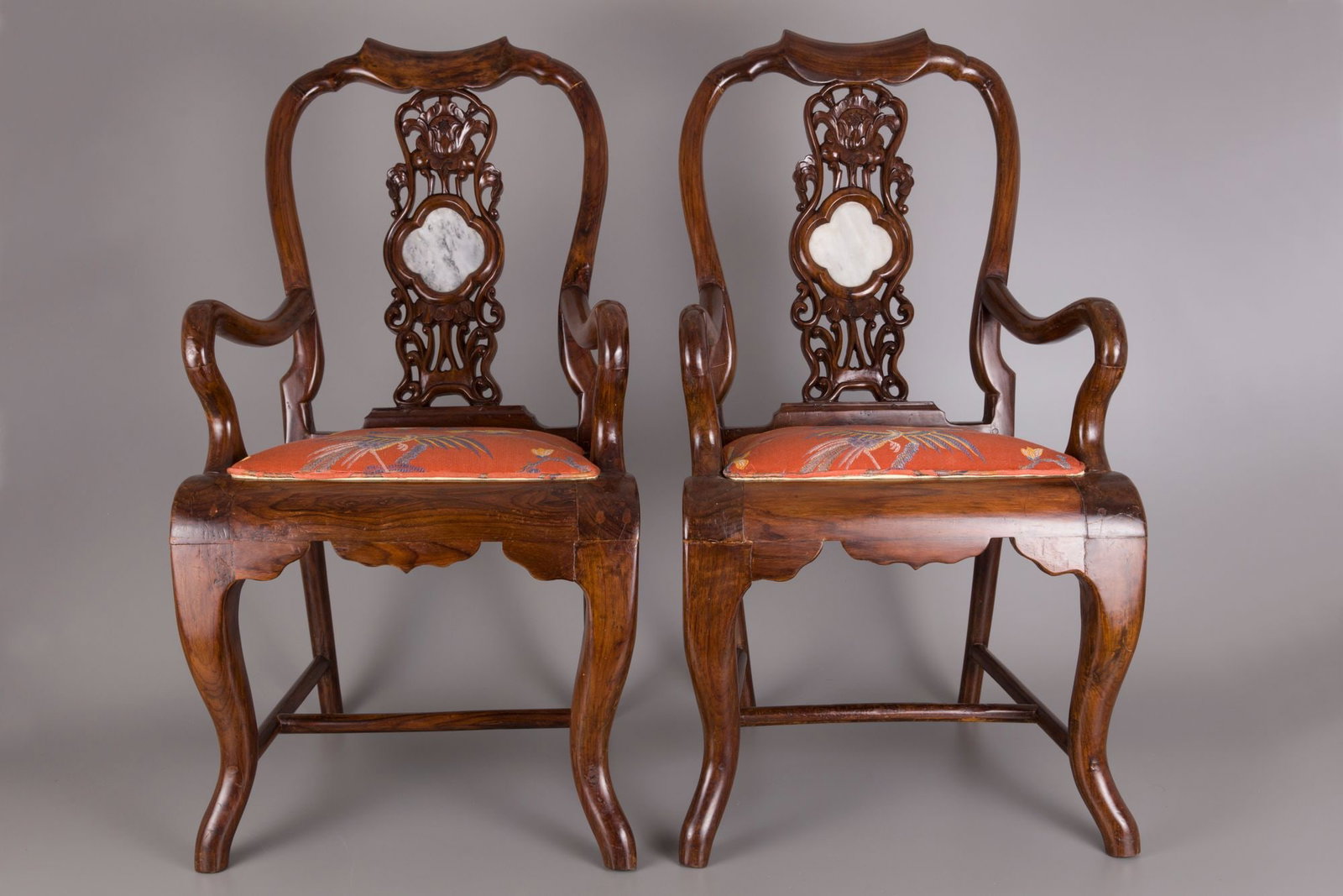 A PAIR OF CHINESE HARDWOOD CHAIRS WITH MARBLE BACKREST: Hardwood chairs with marble inset into the back of each chair, elegant scroll designs with original dark hardwood finish. Width 54 cm. Depth 47 cm. Height 98 cm. Condition: with minor repair.
