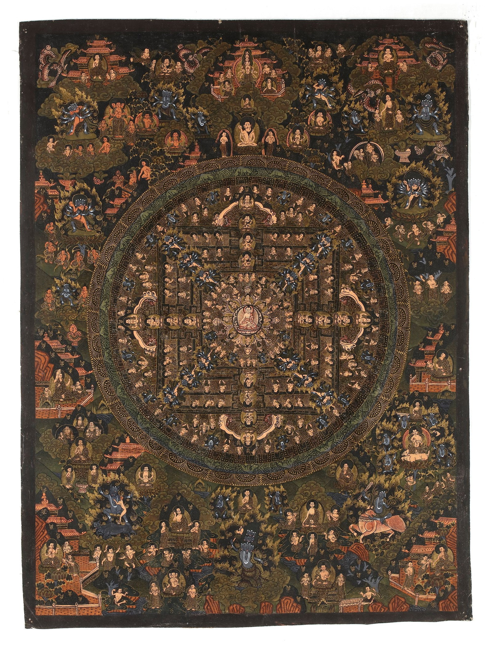 A MANDALA OF BUDDHIST DEITIES, TIBET, 20TH CENTURY: An intricate Tibetan thangka centered on a sacred Buddhist mandala populated by numerous Buddhas, bodhisattvas, and wrathful protector deities. Executed in rich mineral pigments and gold tones, the co