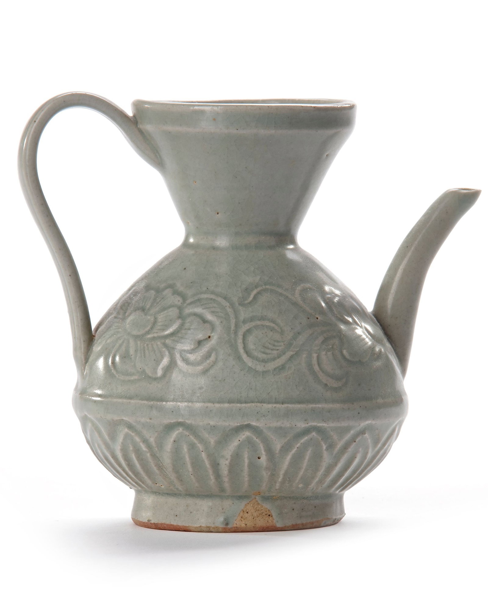 A CHINESE LONGQUAN CELADON EWER, MING DYNASTY (1368-1644): A Chinese porcelain ewer, the pear shaped body with a flaring neck, has a strap handle opposite the short, curved spout. The body covered with attractive light green glaze overall, carved with lotus h