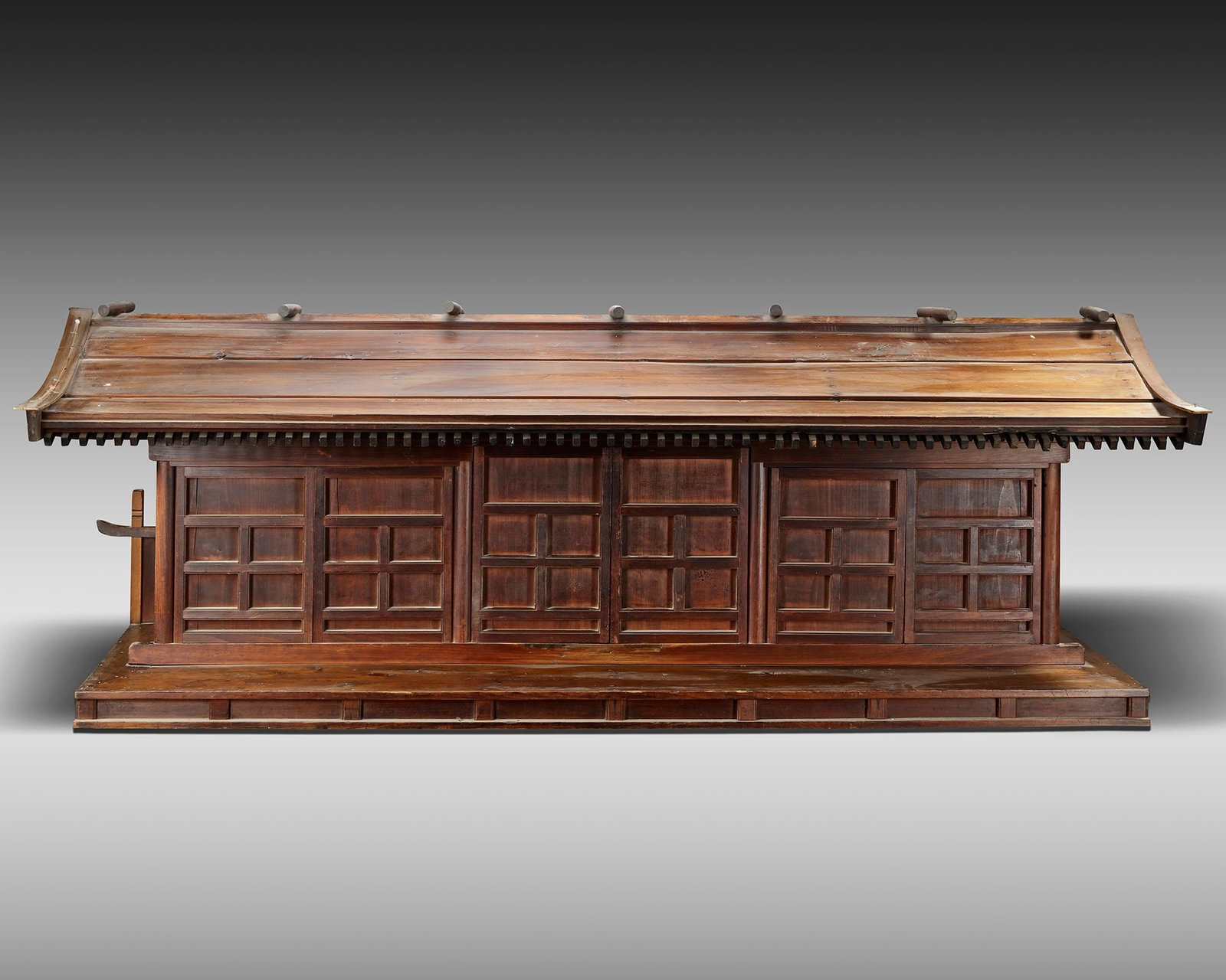 A JAPANESE MODEL OF A SIX 'KEN' WOODEN TEMPLE, 19TH CENTURY: A model of a six ken, the space between pillars that support the roof. Length 175 cm. Height 62 cm. Depth 55 cm.