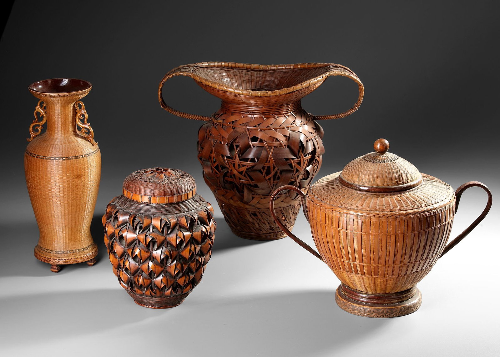 JAPANESE BAMBOO ART COLLECTION, 20TH CENTURY: An elegant set of five Japanese bamboo and wickerwork vessels, showcasing the exceptional craftsmanship of 20th-century basketry masters. Featuring intricate openwork weaving, sculptural forms, and wa