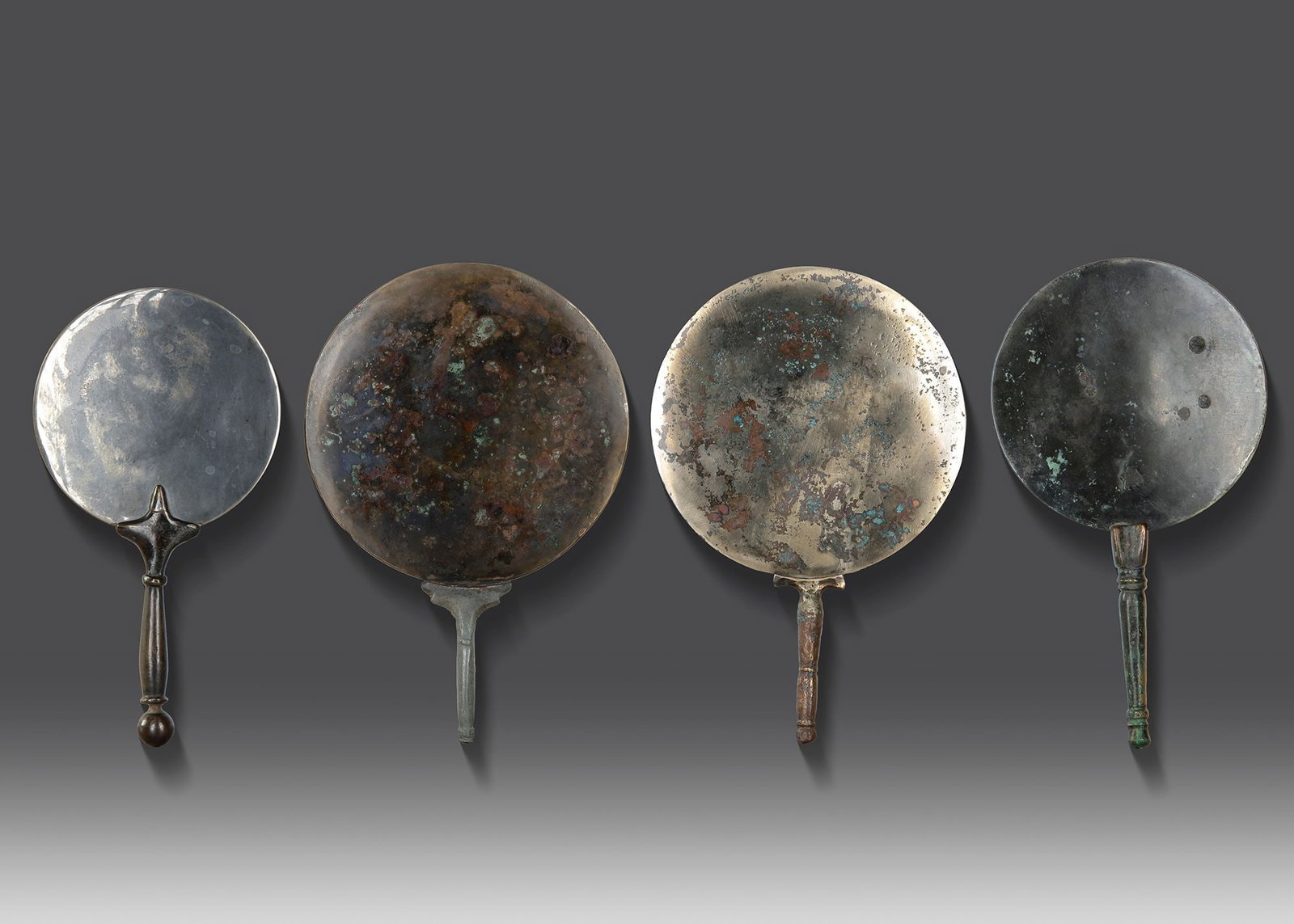 FOUR ROMAN BRONZE MIRRORS, 3RD - 4TH CENTURY AD (1 of 2)