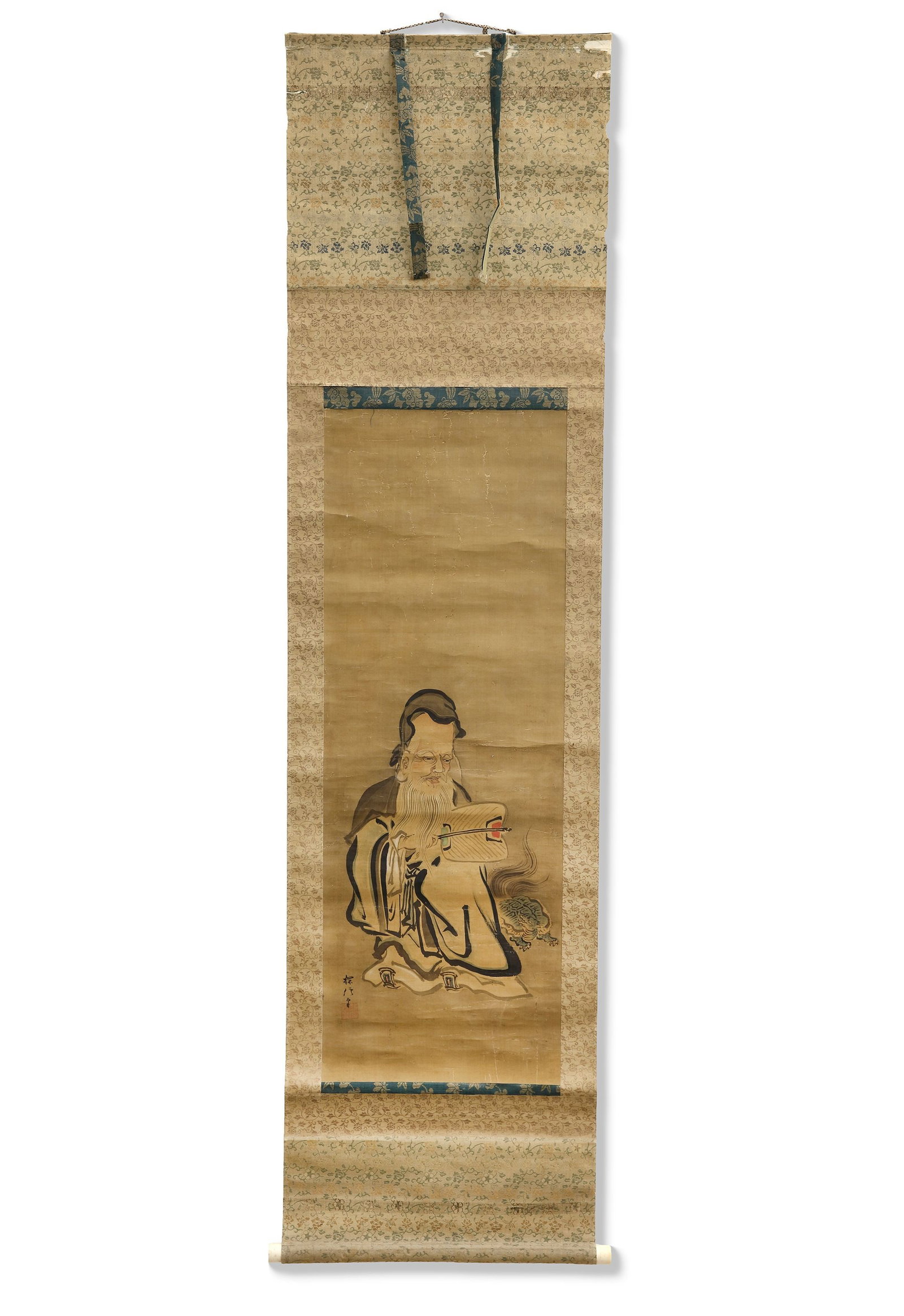A WISE IMMORTAL WITH SACRED TORTOISE, 19TH CENTURY: A striking Japanese hanging scroll portraying a revered immortal or sage accompanied by a sacred tortoise, a traditional symbol of longevity, wisdom, and good fortune. 97 by 35 cm. Total size 175 by 4