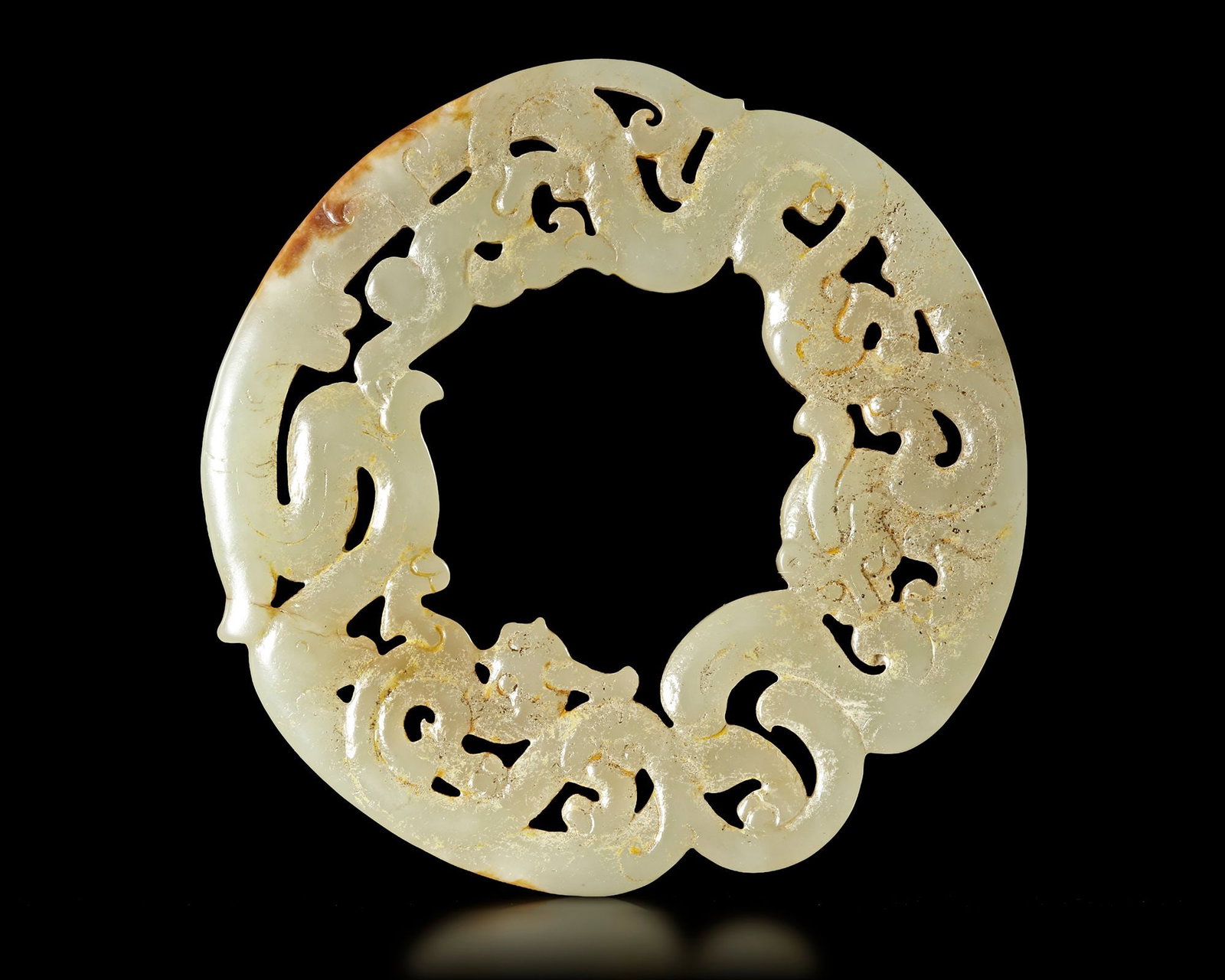 A WHITE JADE DRAGON/PHOENIX RING, HUAN, CHINA, HAN DYNASTY (206 BC-220 AD) (1 of 3)