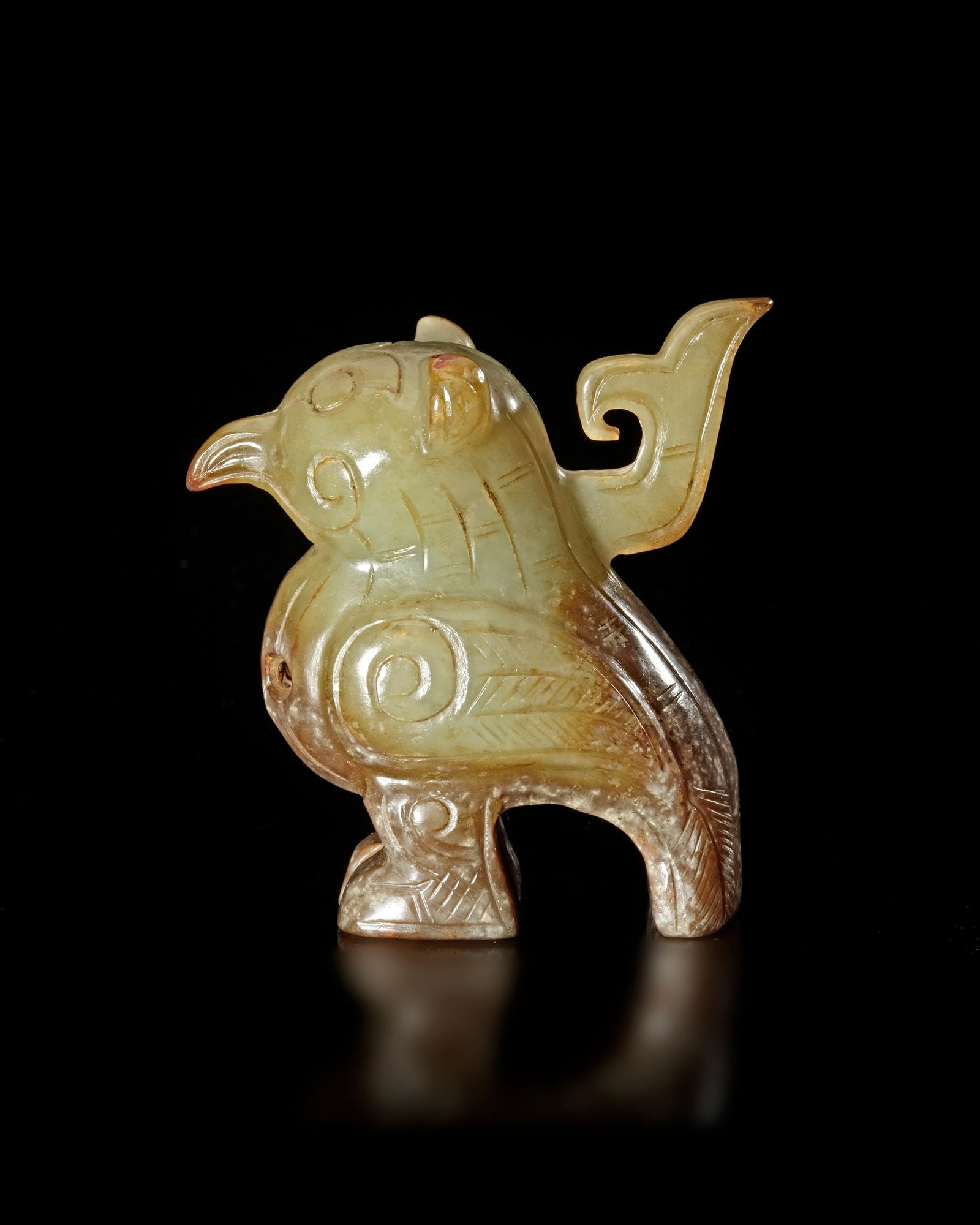 A GREENISH-YELLOW JADE CARVING OF A BIRD, CHINA, SHANG DYNASTY: Height 7 cm. PROVENANCE Purchased in 1996 from Mr. Frank H. Crane, a Canadian antique dealer. His shop, "The Hundred Antiques" was located in Stirling, Ontario, Canada.