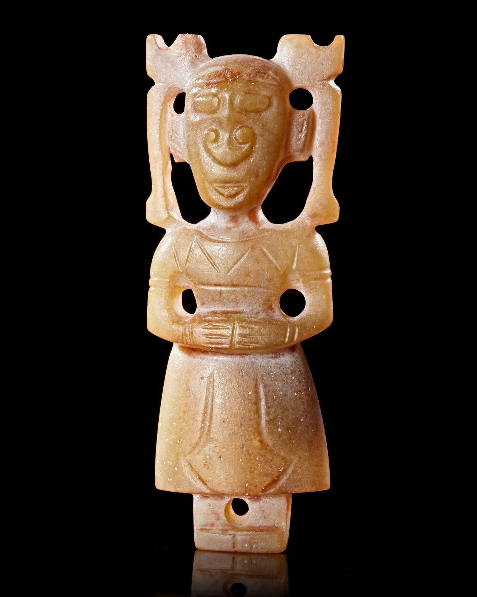 A CHINESE JADE FEMALE FIGURE, SHANG DYNASTY (c. 1600â€“1046 BCE): A rare yellow jade figure depicting a standing woman, carved in a stylized and highly symbolic form characteristic of Shang Dynasty craftsmanship. Small perforations suggest it may have served as a ri
