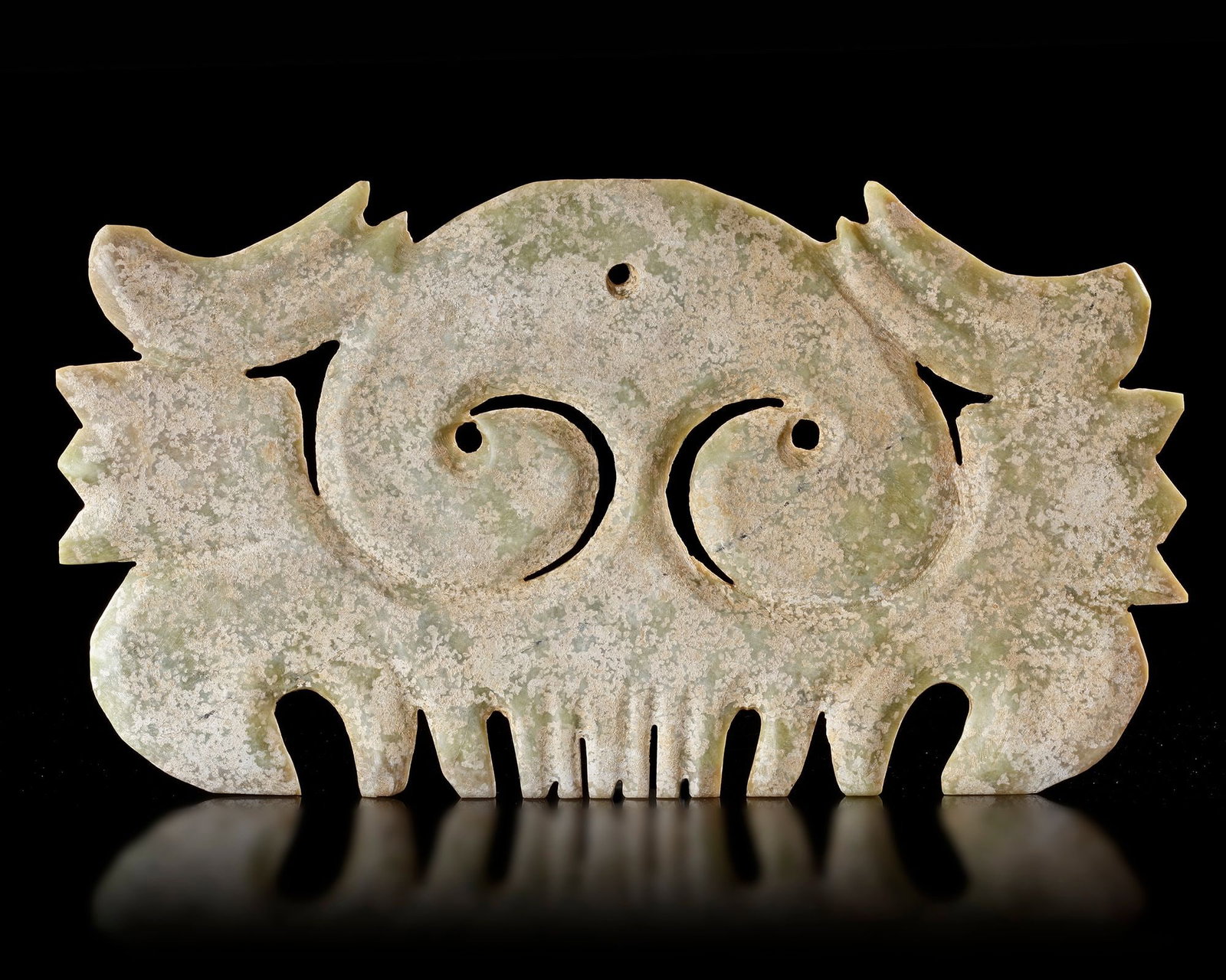 A CHINESE JADE â€?TOOTHEDâ€? PENDANT, HONGSHAN CULTURE (c 3500 BC): A monumental calcified light green jade pendant of â€?toothedâ€? form from the Hongshan culture. Expertly carved with sweeping curves and archaic motifs, this impressive ceremonial object 