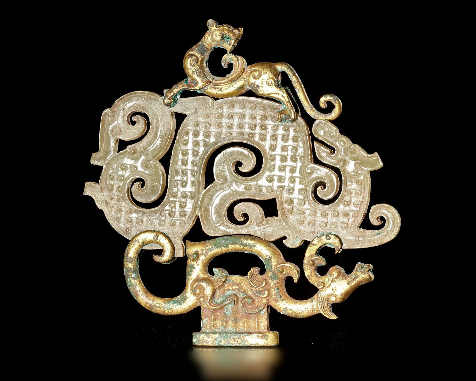 A GILT BRONZE MOUNTED OPENWORK DOUBLE DRAGON JADE HENG, CHINA, WARRING STATES: 14 cm. PROVENANCE Purchased in 1996 from Mr. Frank H. Crane, a Canadian antique dealer. His shop, "The Hundred Antiques" was located in Stirling, Ontario, Canada.