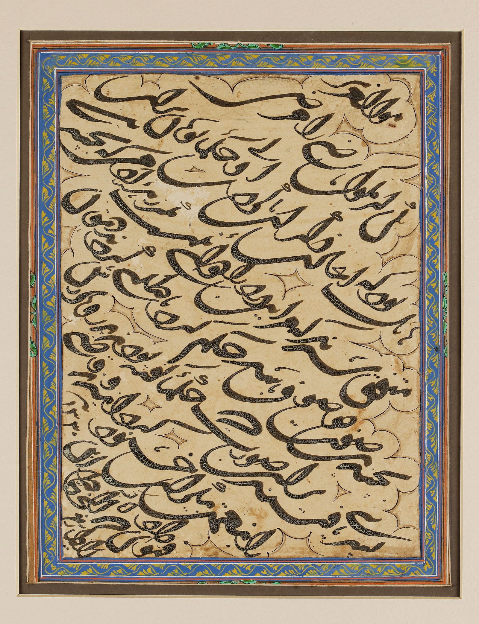 AN OTTOMAN CALLIGRAPHIC PANEL, TURKEY AND DATED 1330 AH/1911 AD: Arabic manuscript on paper, 8 lines, written diagonally in black naskh script, reserved in clouds, ruled with polychrome borders, the margins stylized with yellow floral scrolls on a blue ground. The 