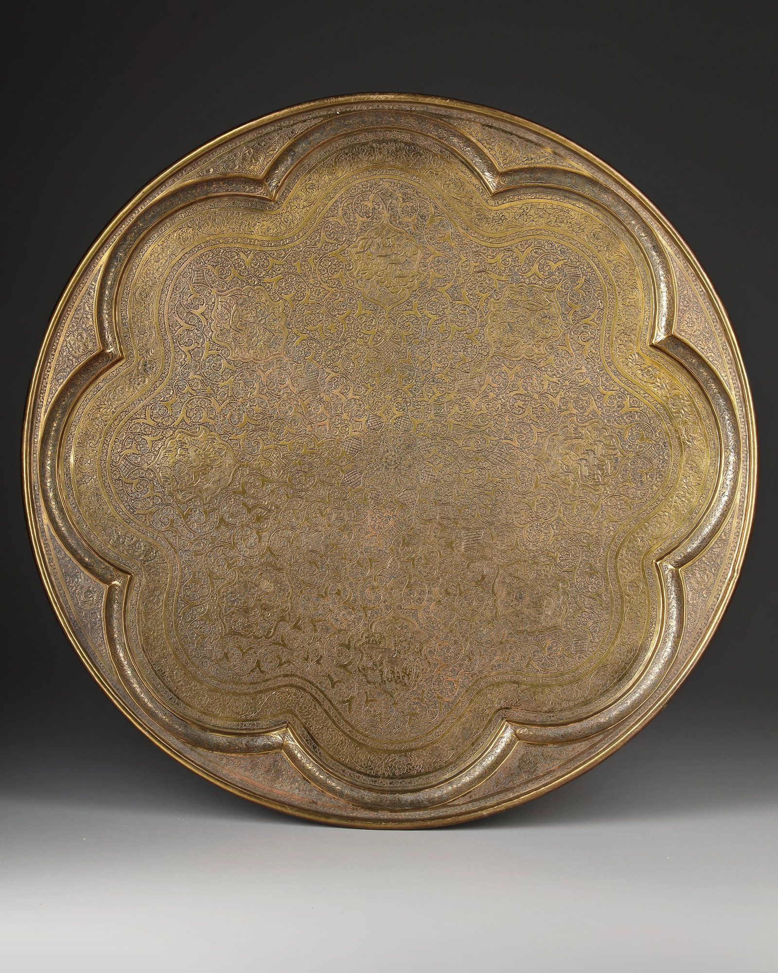 A QAJAR ENGRAVED BRASS TRAY, PERSIA, 19TH-20TH CENTURY (1 of 3)