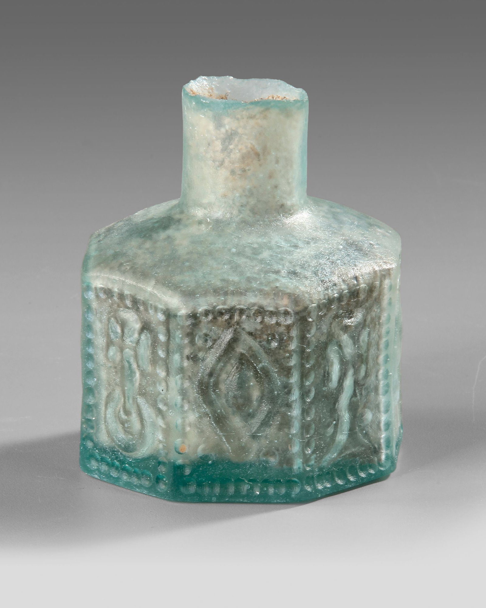 A MOLDED HEXAGONAL GLASS BOTTLE, 7THâ€“9TH CENTURY (1 of 4)