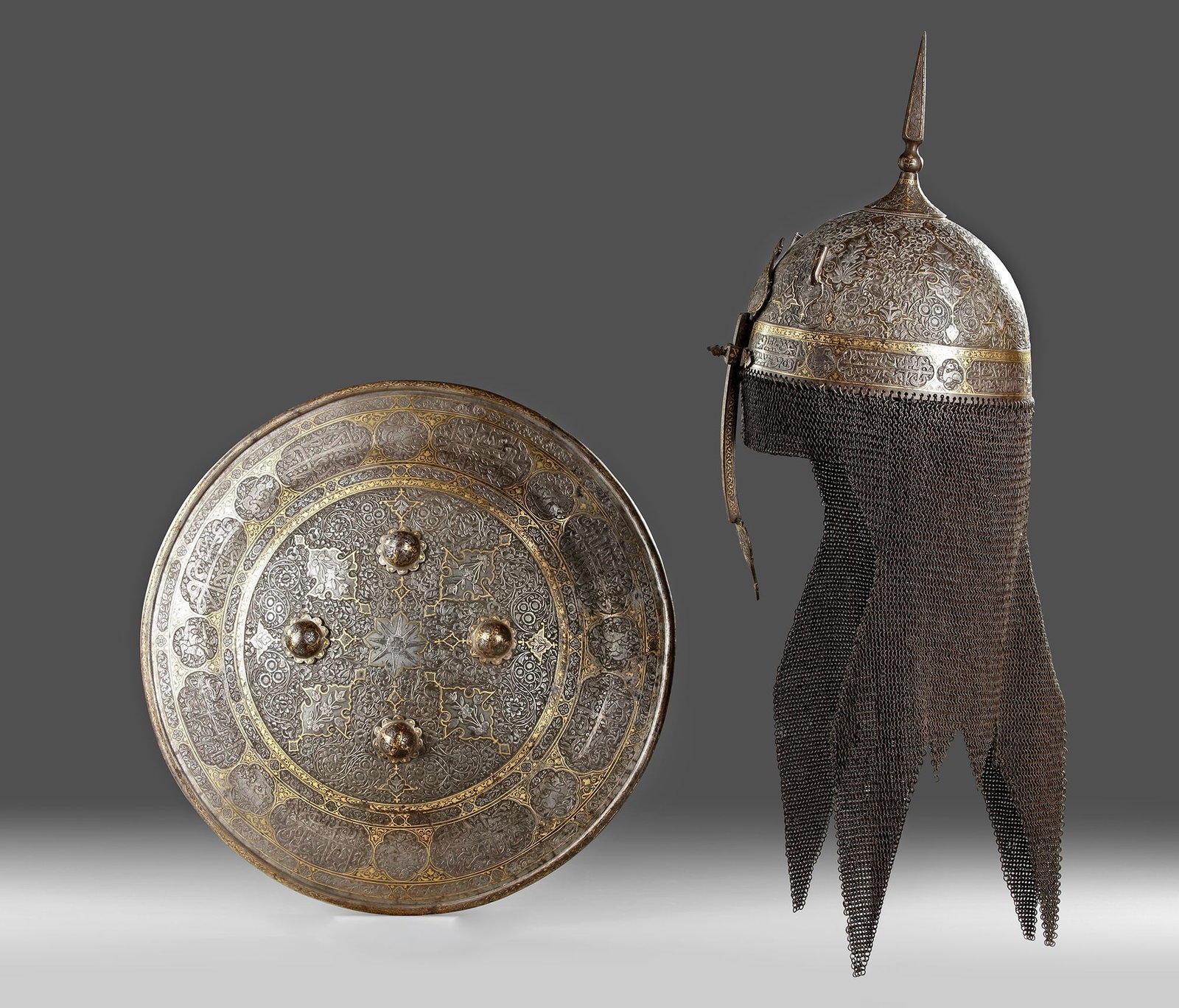 A GOLD-DAMASCENED STEEL HELMET AND SHIELD, QAJAR, PERSIA, EARLY 19TH CENTURY (1 of 2)