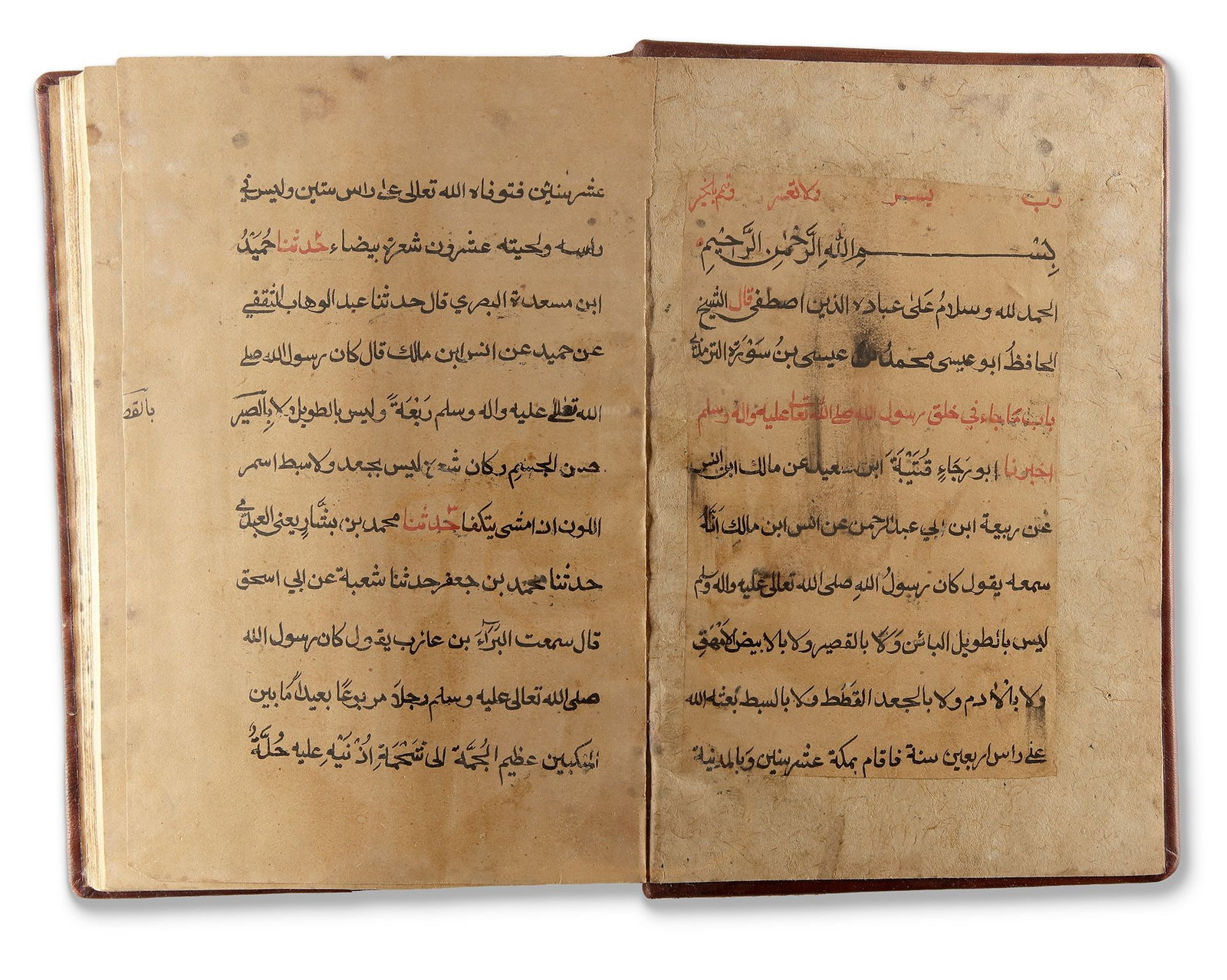 SHAMAâ€™IL AL-NABI: ARABIC MANUSCRIPT ON THE PROPHETIC ATTRIBUTES, DAST BINIL, DATED 1284 AH /: Arabic manuscript on paper, each page arranged in 11 lines of elegant black Naskh script, with titles, important words and catchwords highlighted in red ink. Housed in brown leather binding embossed w