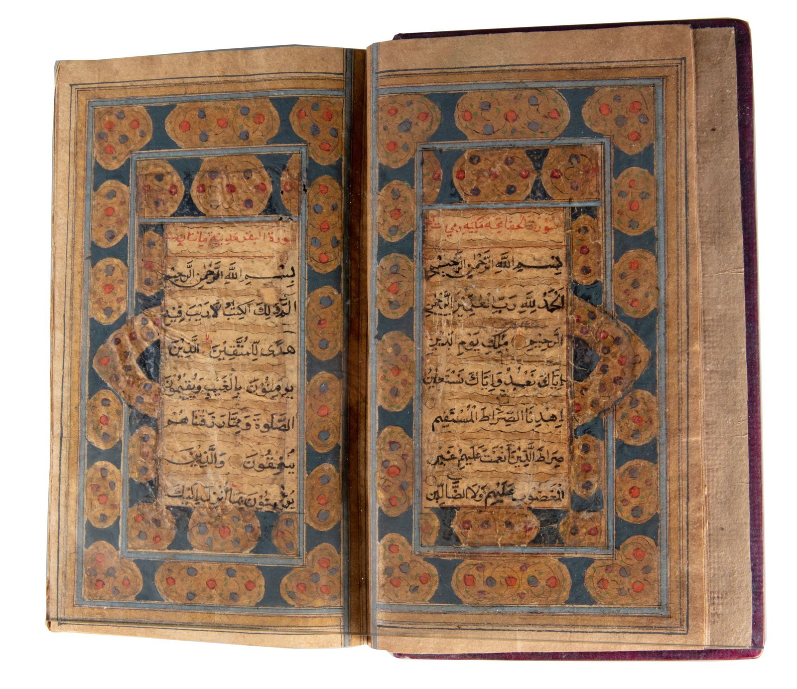 AN ILLUMINATED QURAN, EARLY 19TH CENTURY: Arabic manuscript on paper, each page arranged in 11 lines of neat black Naskh script, with gilt verse roundels outlined in black. Tajwid markings and diacritical signs are rendered in red ink, while 