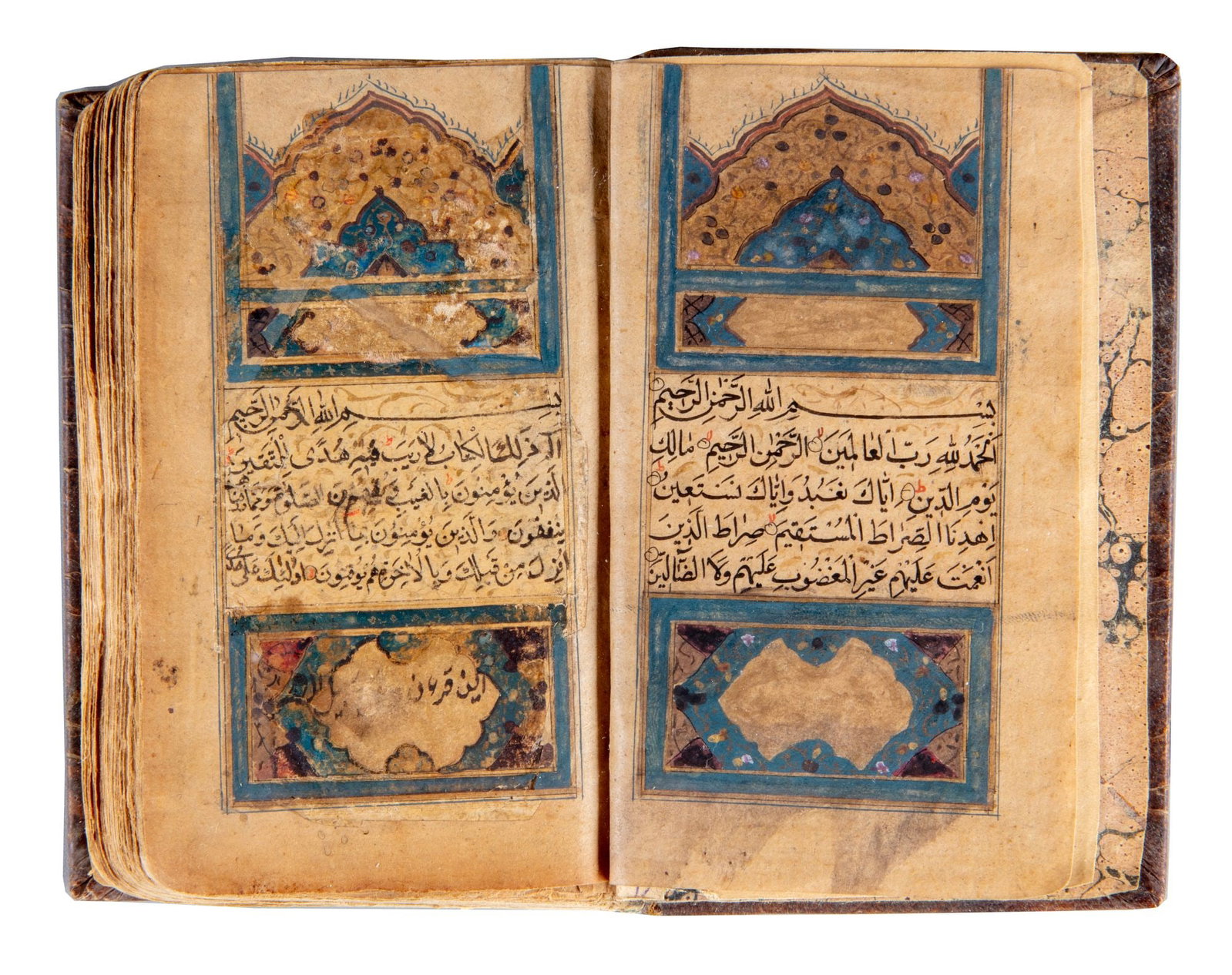 AN ILLUMINATED QURAN, 19TH CENTURY: A small-format Arabic Quranic manuscript on paper, each page arranged in 15 lines of neat black Naskh script, with verses separated by small red roundels. Tajwid markings and diacritical signs are ren