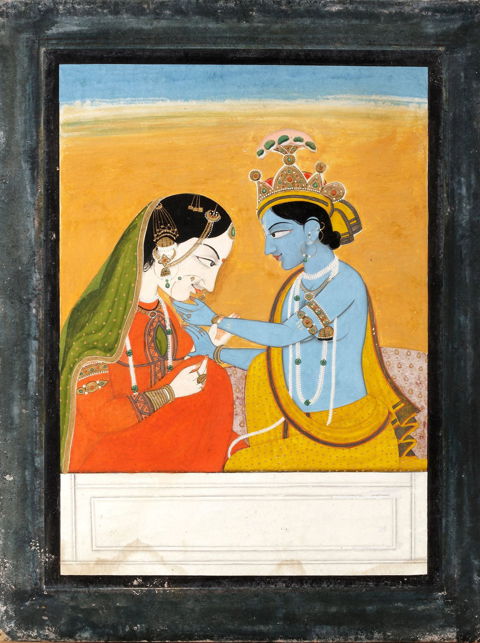 RADHA AND KRISHNA, KANGRA SCHOOL, 19TH CENTURY: Radha and Krishna Kangra School, 19th century Blue-skinned Krishna, crowned with a peacock feather, tenderly holds the face of Radha as they sit closely together against a plain golden background. 20 