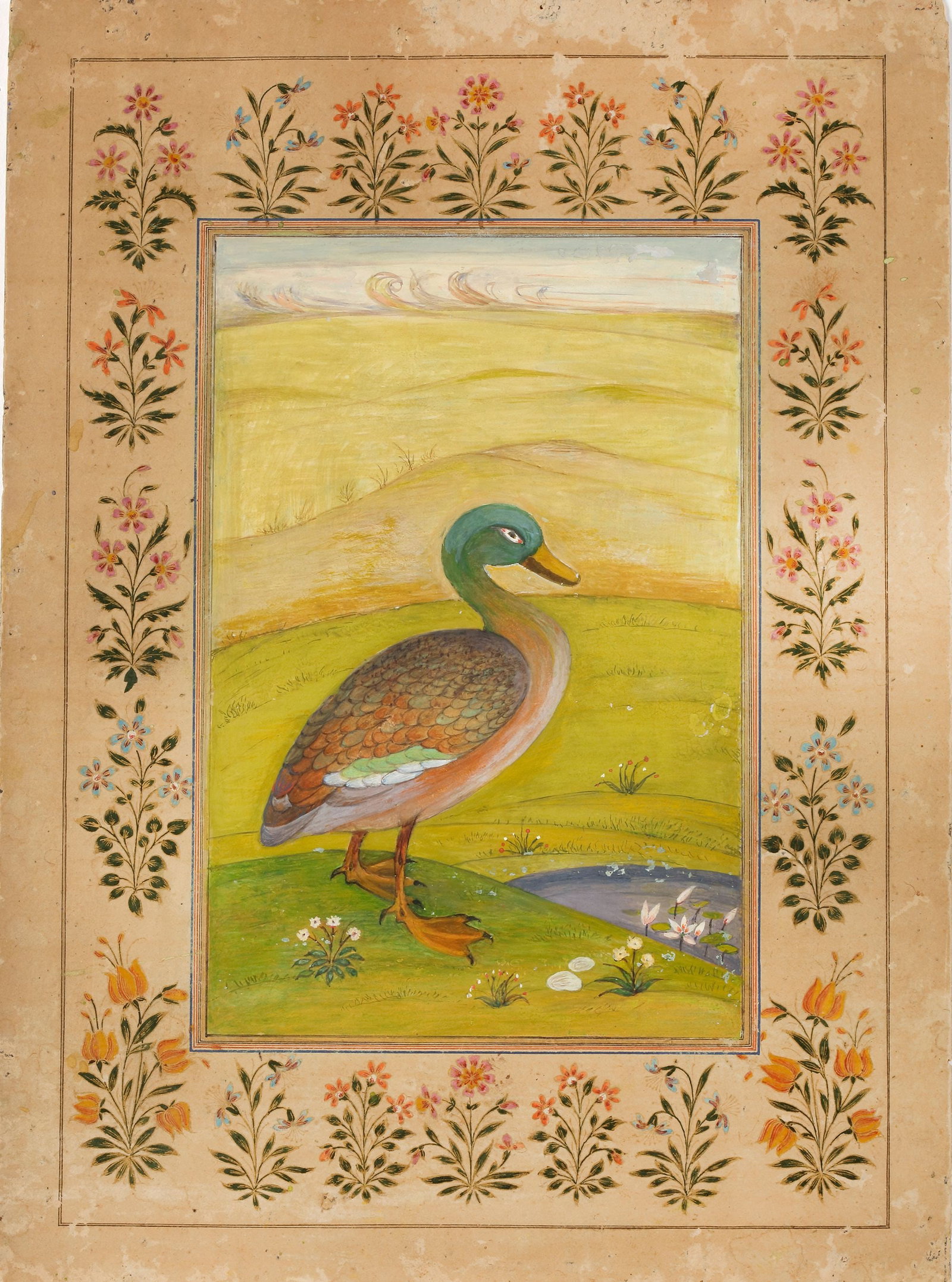 DUCK IN A LANDSCAPE, INDIA EARLY 20TH CENTURY: Watercolour on paper, depicting a finely rendered duck standing beside a tranquil stream, surrounded by flowering plants and rolling countryside beneath a softly painted sky. The bird is depicted with