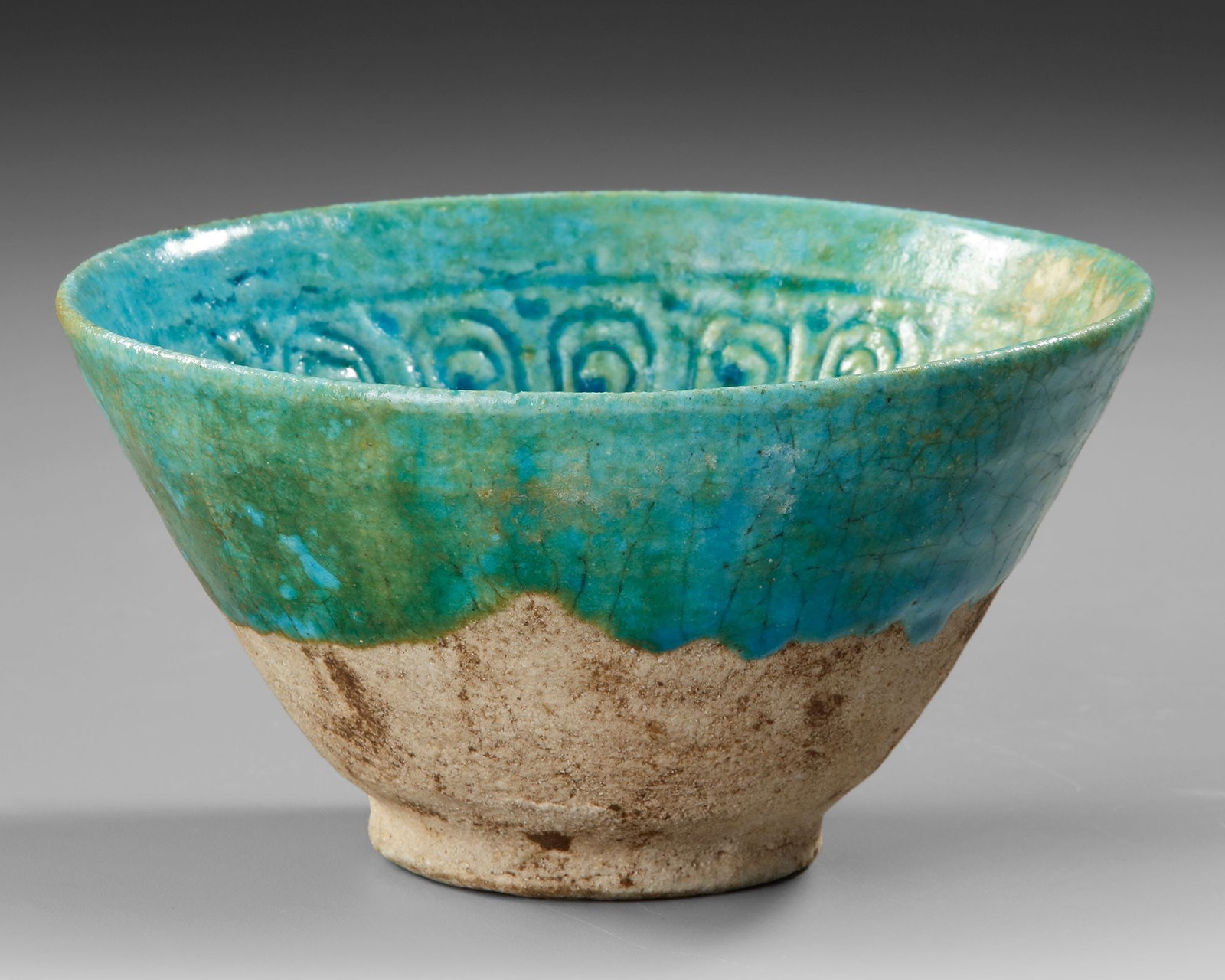 A BAMIYAN MONOCHROME MOULDED POTTERY BOWL, PERSIA, 12TH-13TH CENTURY (1 of 4)