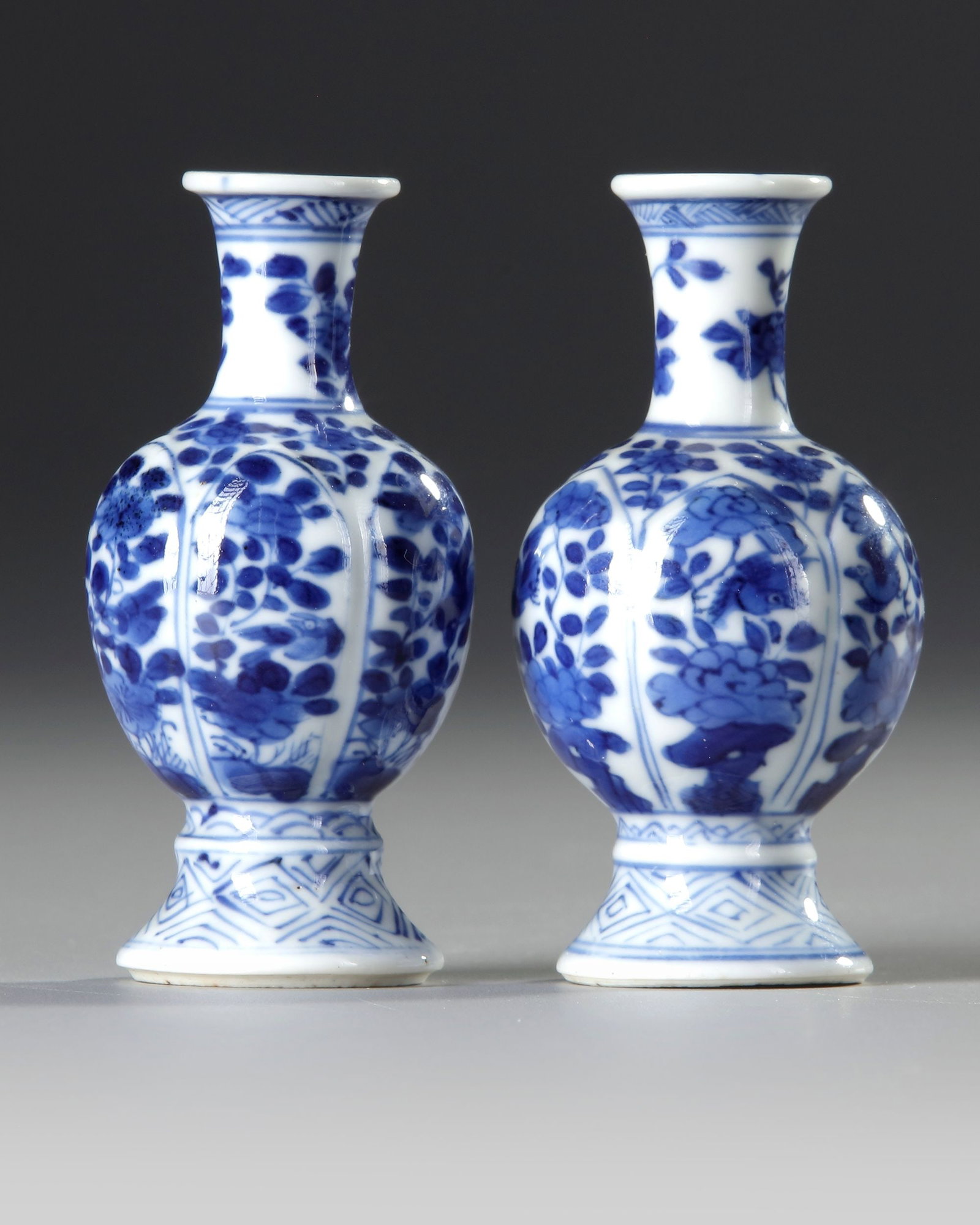 A PAIR OF BLUE AND WHITE â€?FLOWER AND FOLIAGEâ€™ VASES, KANGXI PERIOD (1 of 3)