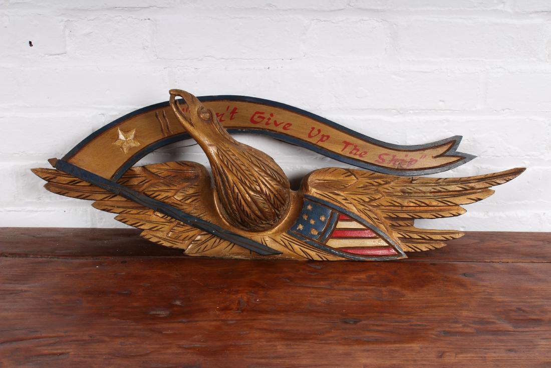 Bellamy Carved Gilt Wood Eagle: A good bellamy style carved gilt wood and painted spread wing eagle. Banner reads "Don't give up the ship". 20th century. Size: 9" H x 28" W