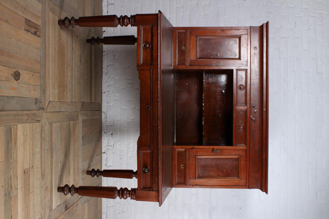 Late 19th Century Railroad Clerks Desk: Late 19th Century railroad clerks desk with upper strapped back section with hidden compartment over 2 drawers and 2 doors resting on slat lid desk over 3 drawers all supported on turned and tapered l