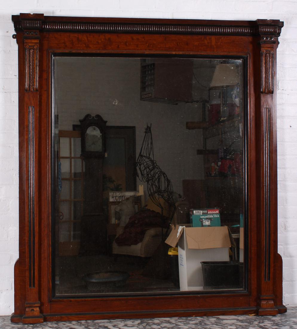 English Late 19th C Carved Oak Library Mirror: English Late 19th C Carved Oak Library Mirror. Having a stepped cornice and beveled mirror flanked by carved plasters. Size: 63" x 56".