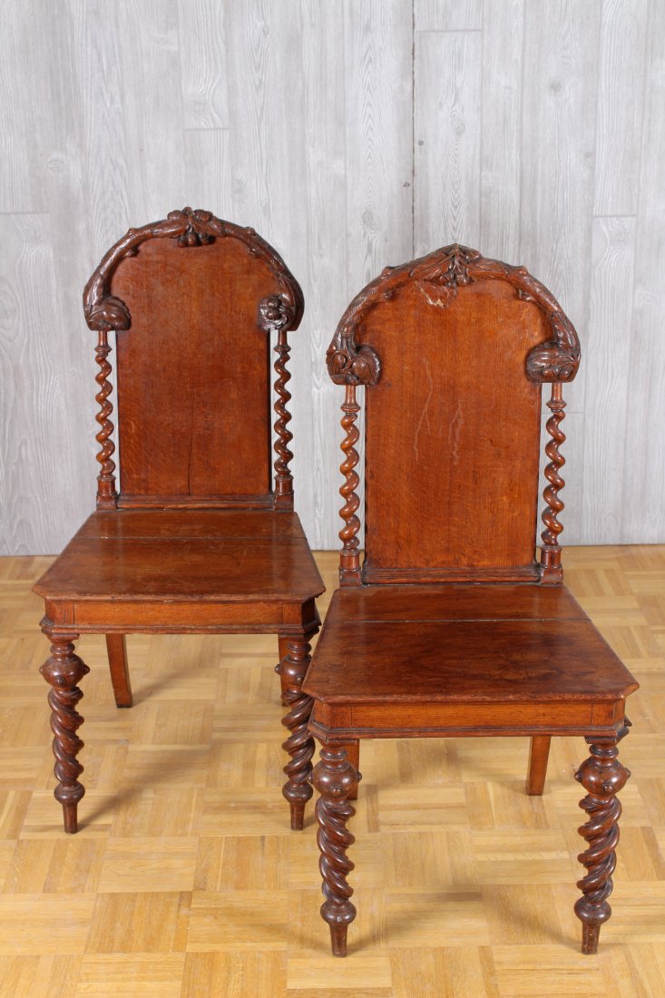 Pair 19th C Black Forest Side Chairs: Pair of late 19th century Black Forest carved oak side chairs each with acorn, leaf and branch decorated backs framed by barley twist columns over plank wood seats and turned legs. Circa 1880 Size: 38